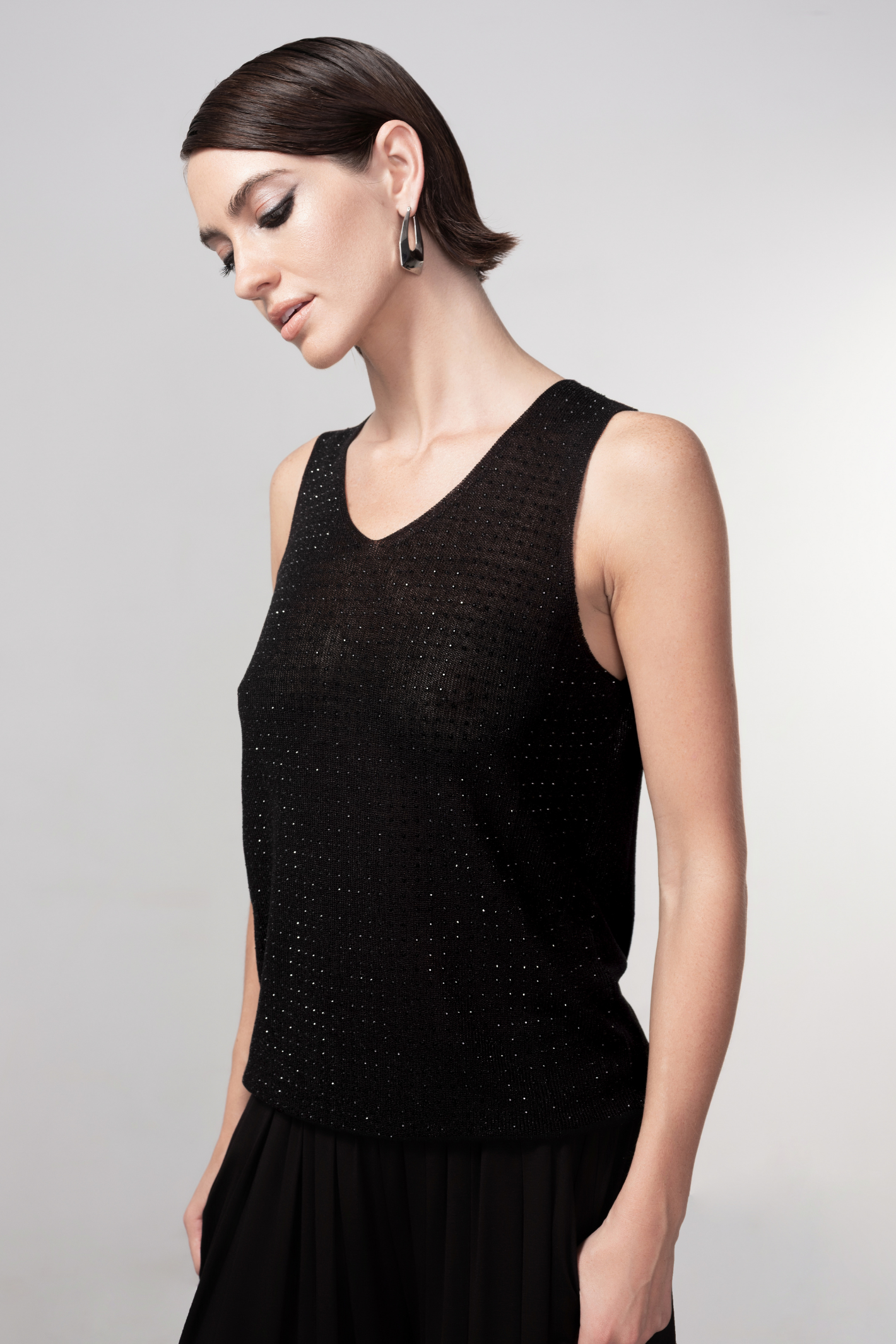 Haako black sparkle knit vest styled in a modern minimalist outfit at Dotique