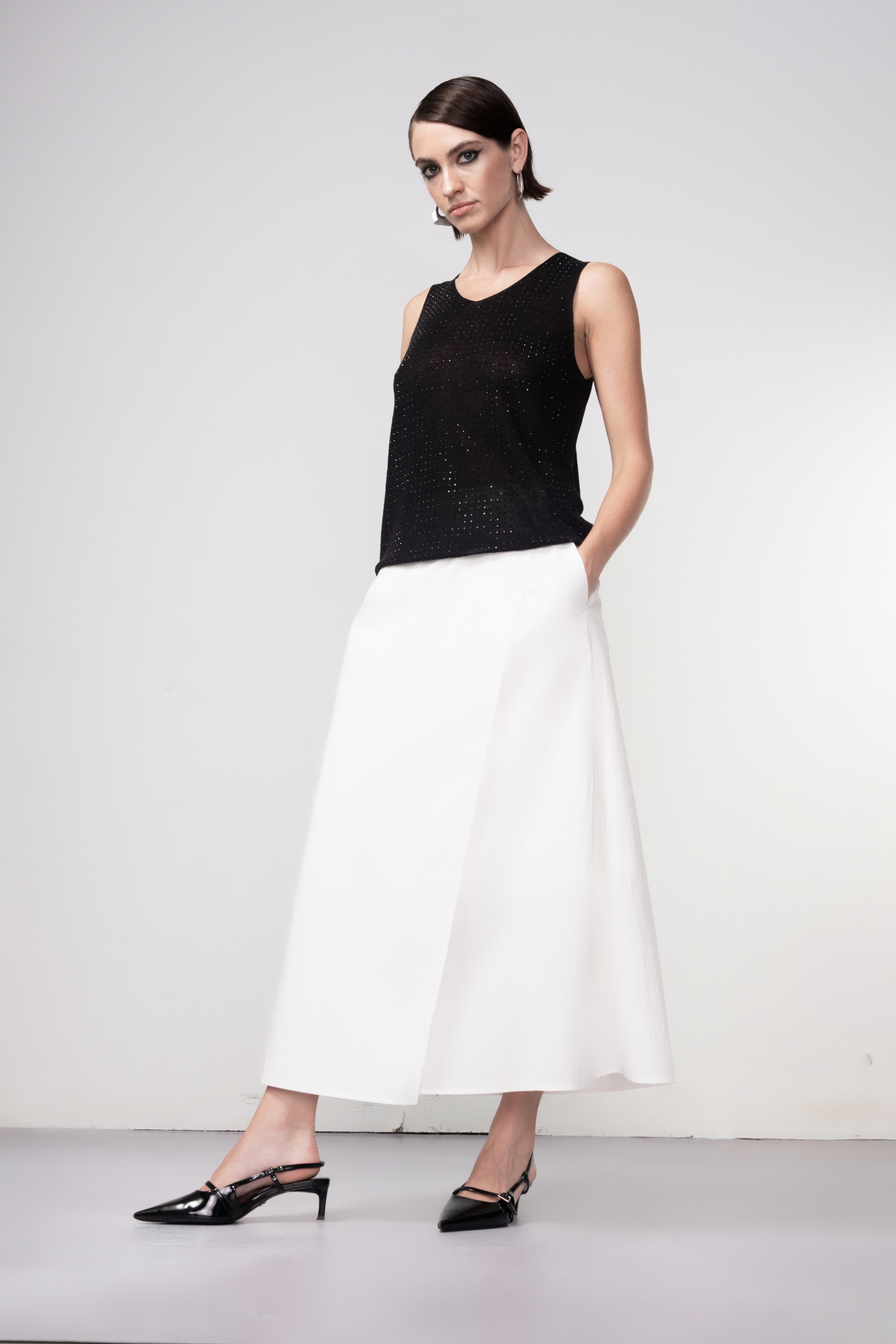 Haako black sparkle knit vest styled in a modern minimalist outfit at Dotique