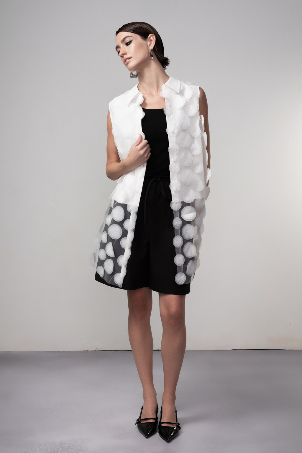 Haako white sheer long vest with circle detail styled in a minimalist layered look at Dotique