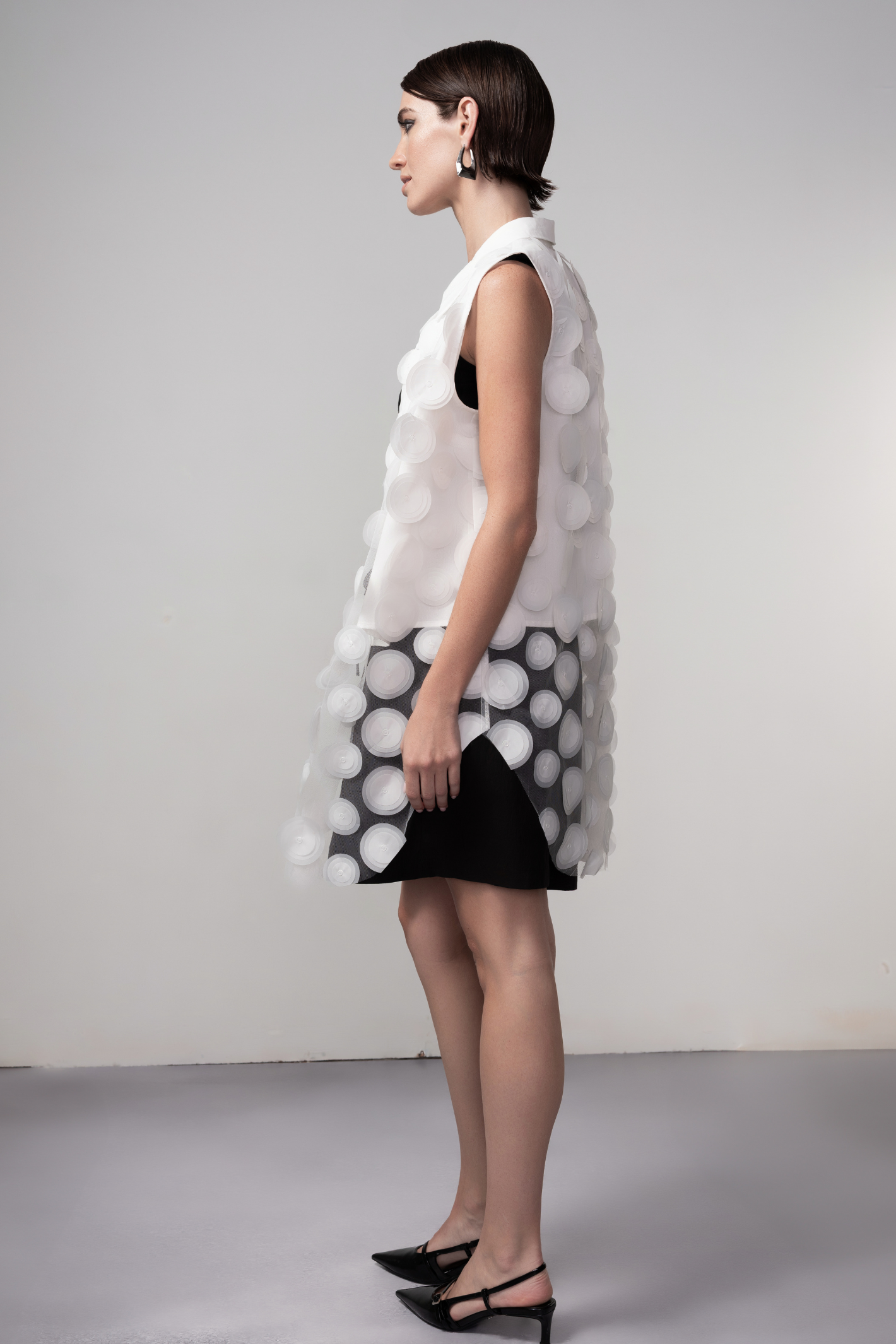 Haako white sheer long vest with circle detail styled in a minimalist layered look at Dotique