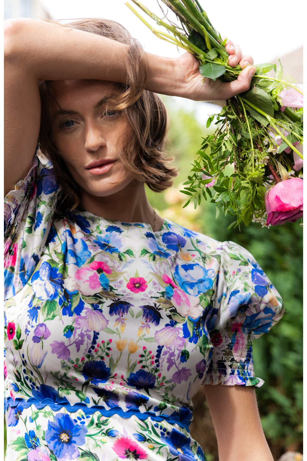 Close-up of a woman wearing Hope & Ivy Charlotte Ann Puff Sleeve Maxi Dress Blue Floral by Hope and Ivy Shop Dotique