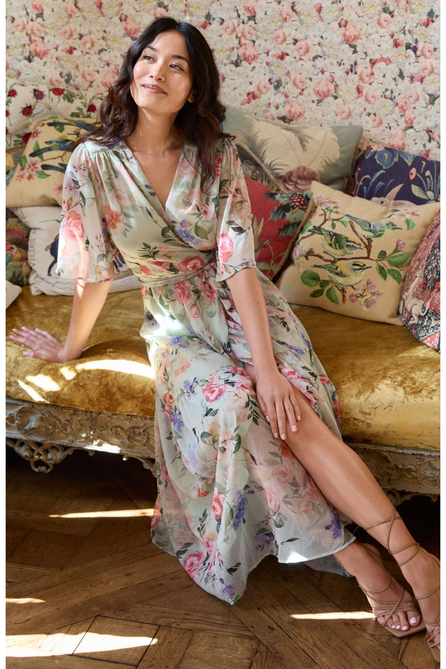 Woman wearing Hope & Ivy The Emi Flutter Sleeve Floral Wrap Maxi Dress Green by Hope and Ivy Shop Hope and Ivy at Dotique