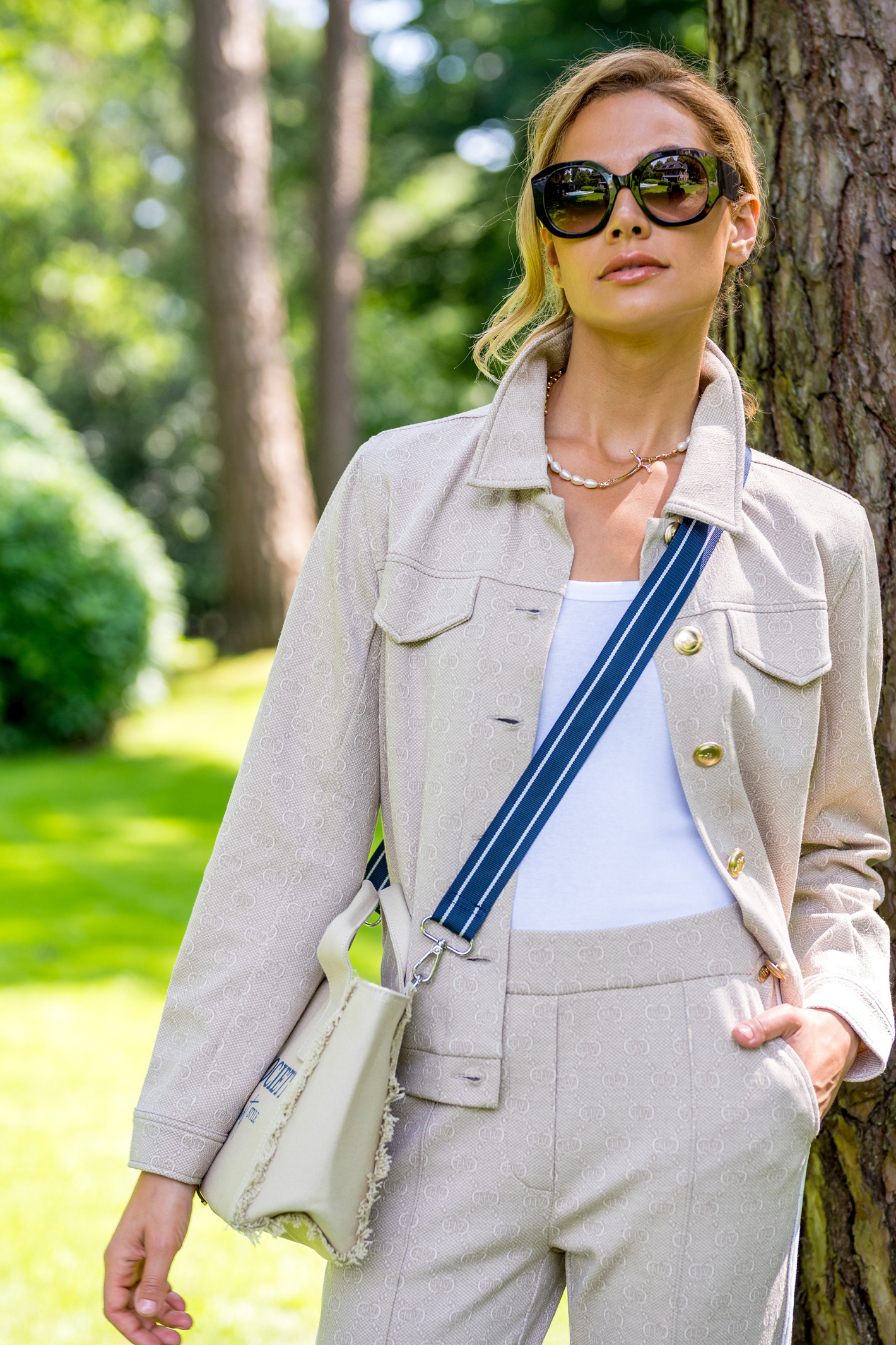 HV Society Natalie jacket in sand with subtle monogram and gold buttons. Soft stretch fabric for a flattering, comfortable fit. Shop at Dotique.