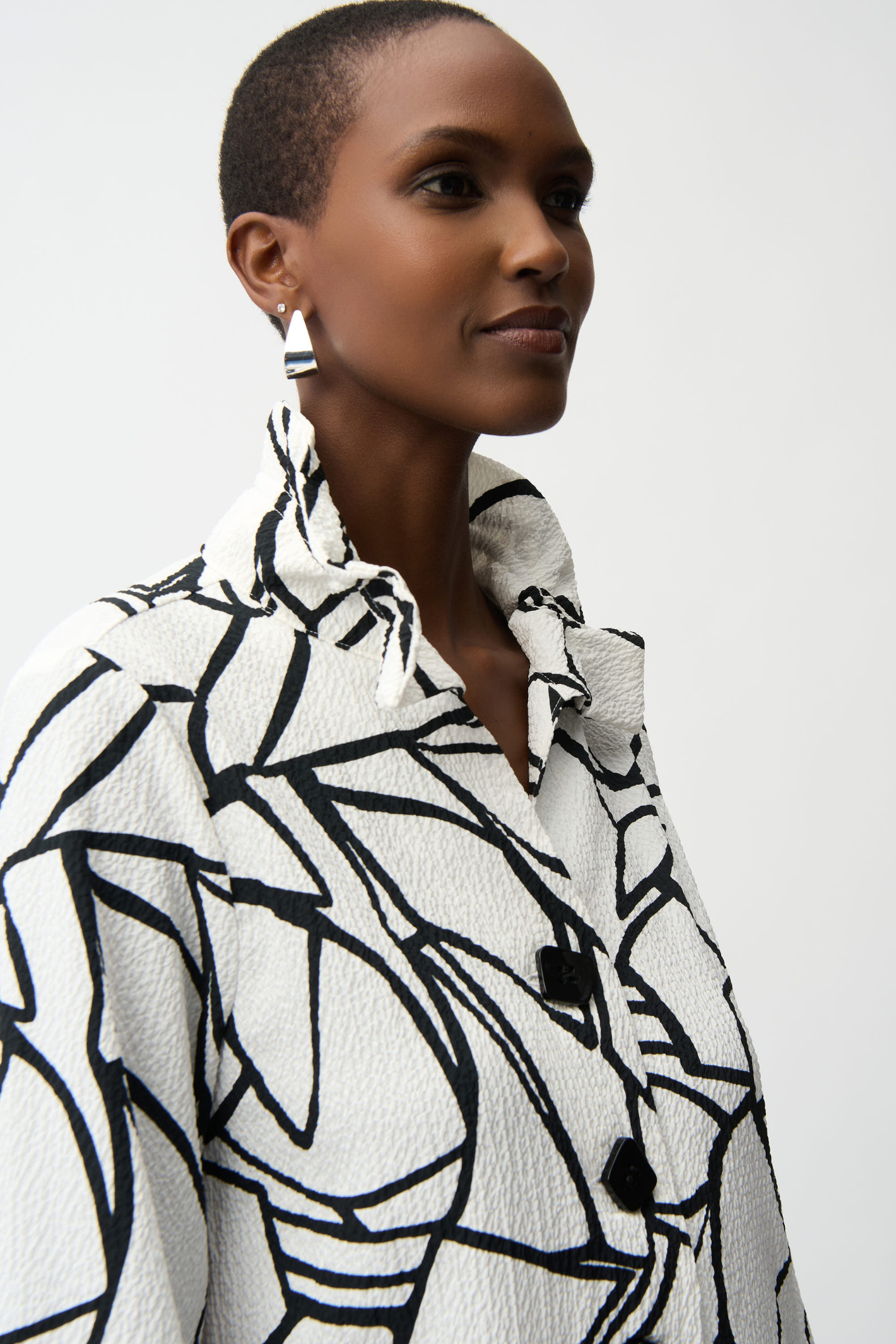 Joseph Ribkoff vanilla and black abstract seersucker trapeze jacket with contrast buttons at Dotique