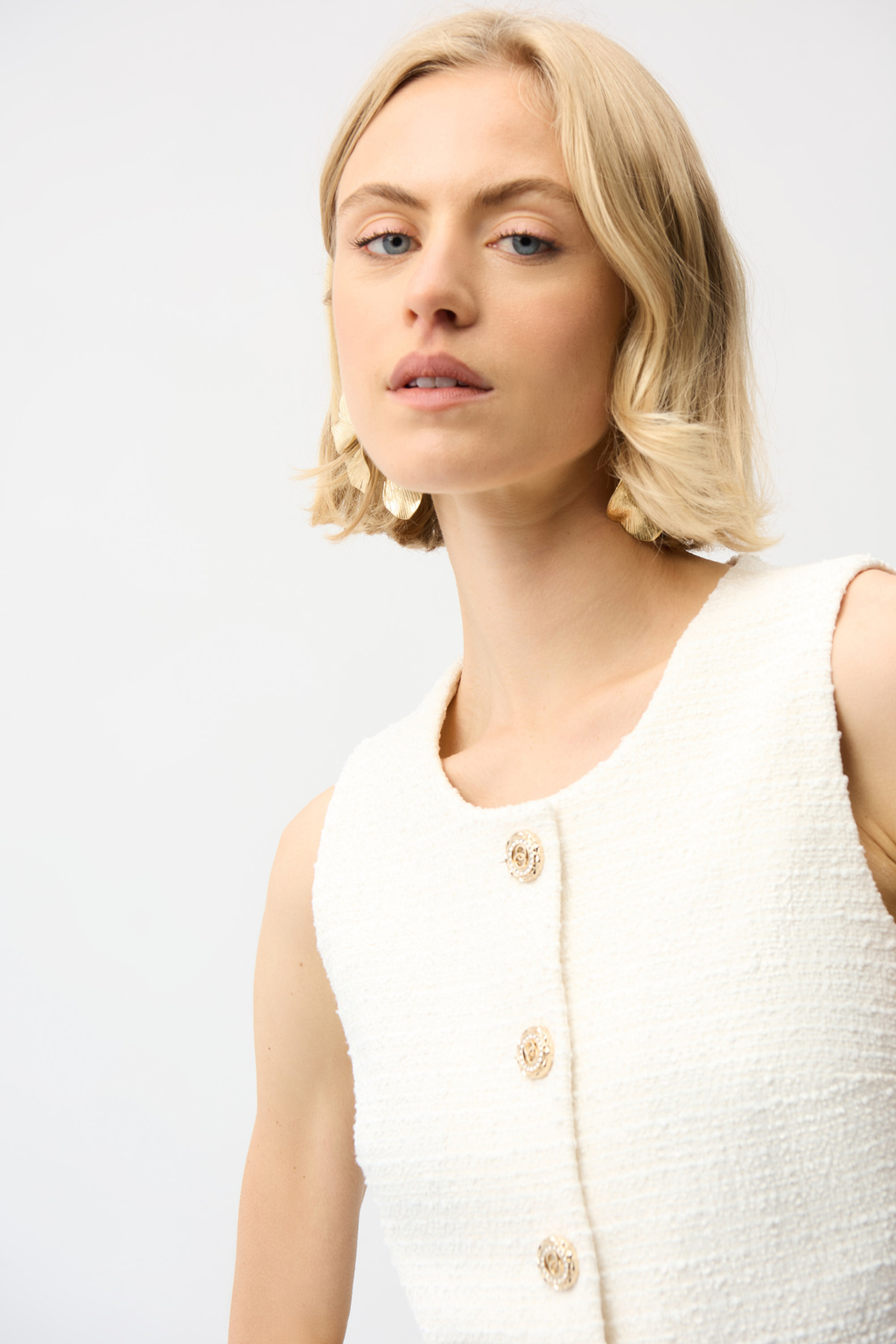 Women’s off-white bouclé vest with gold button front by Joseph Ribkoff