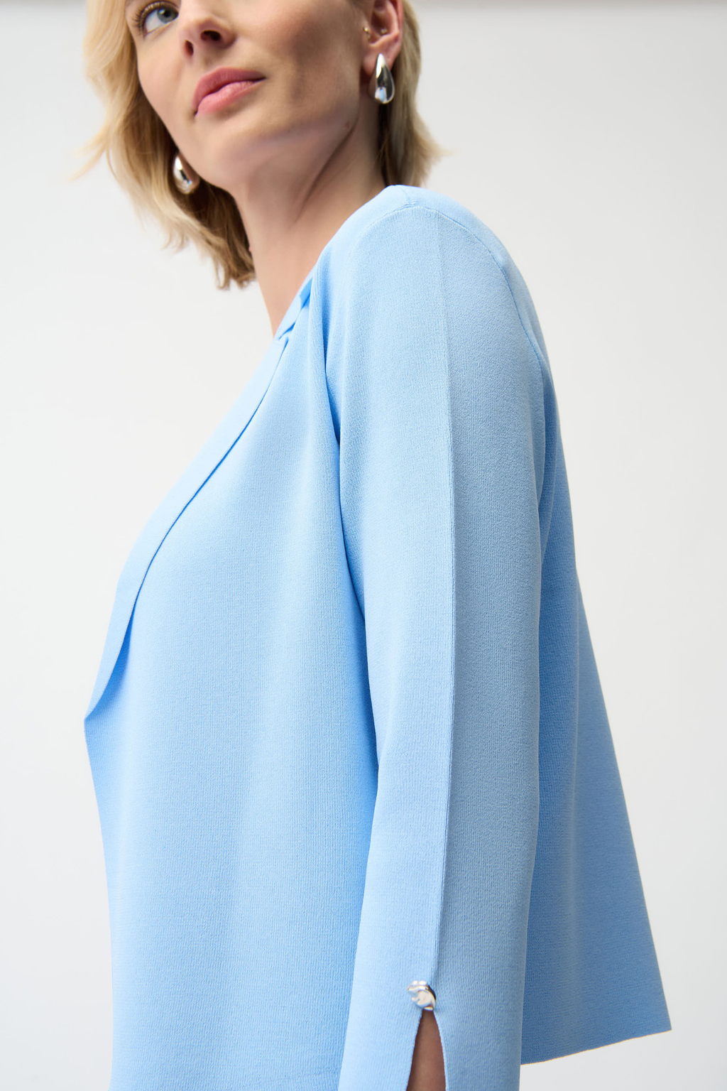 Women’s lightweight sky blue cardigan with slit sleeves and button detail by Joseph Ribkoff.