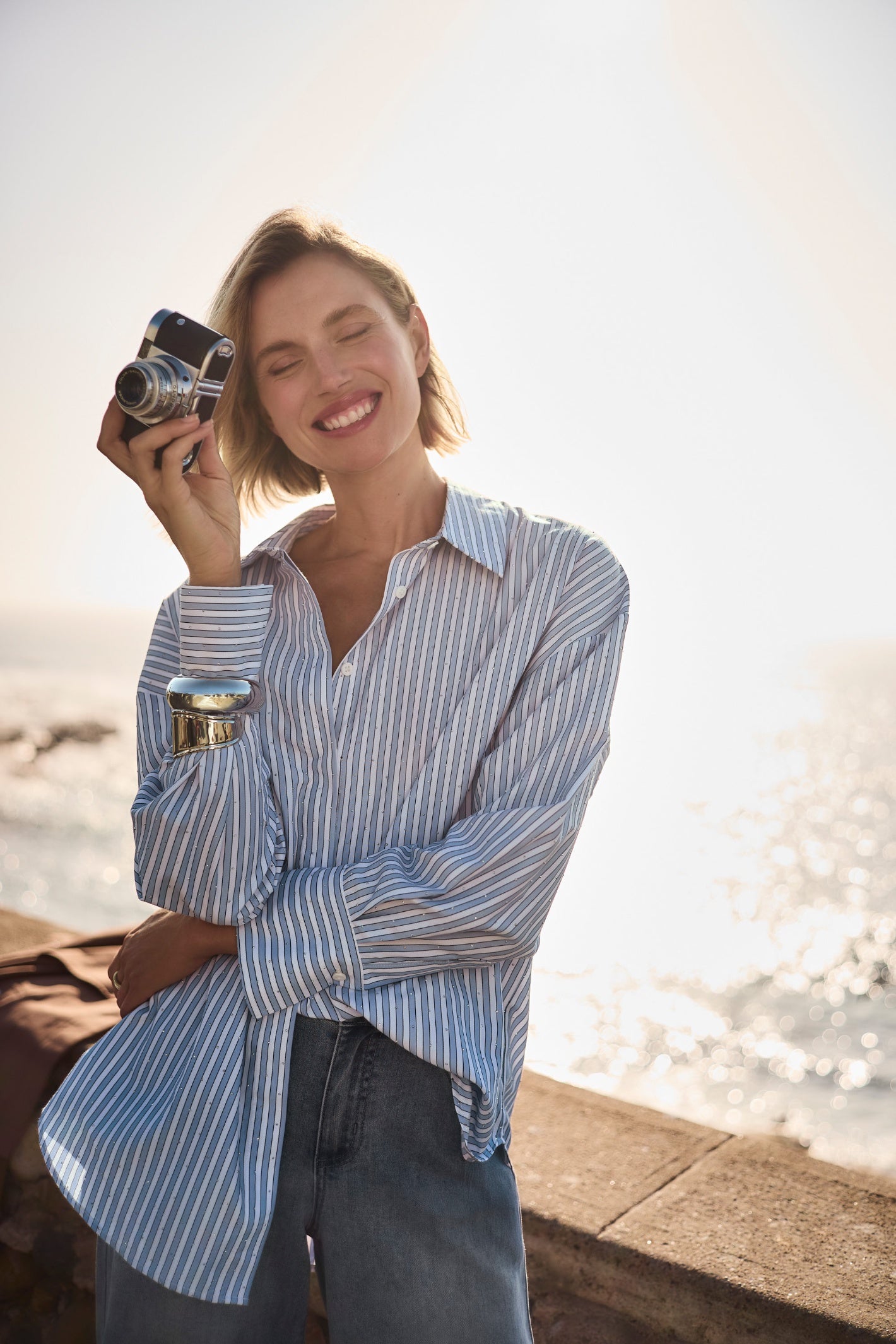 Joseph Ribkoff 261931 Blue/ Vanilla Tencel Stripe Print Boxy Blouse by joseph ribkoff shop the vendor at Dotique model outdoors front view