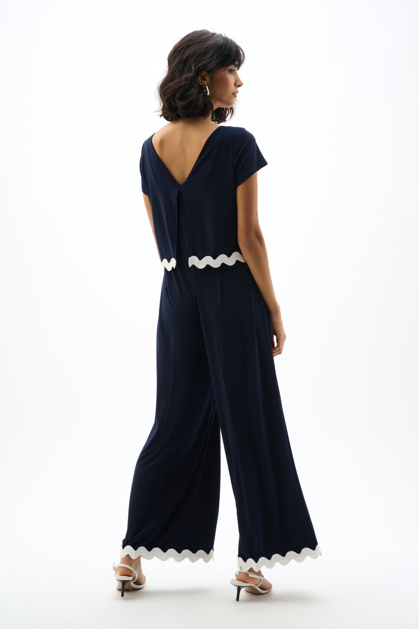 Joseph Ribkoff 262144 Navy Silky Knit Culotte Jumpsuit With Contrast Trim by joseph ribkoff shop the brand at Dotique back pose view