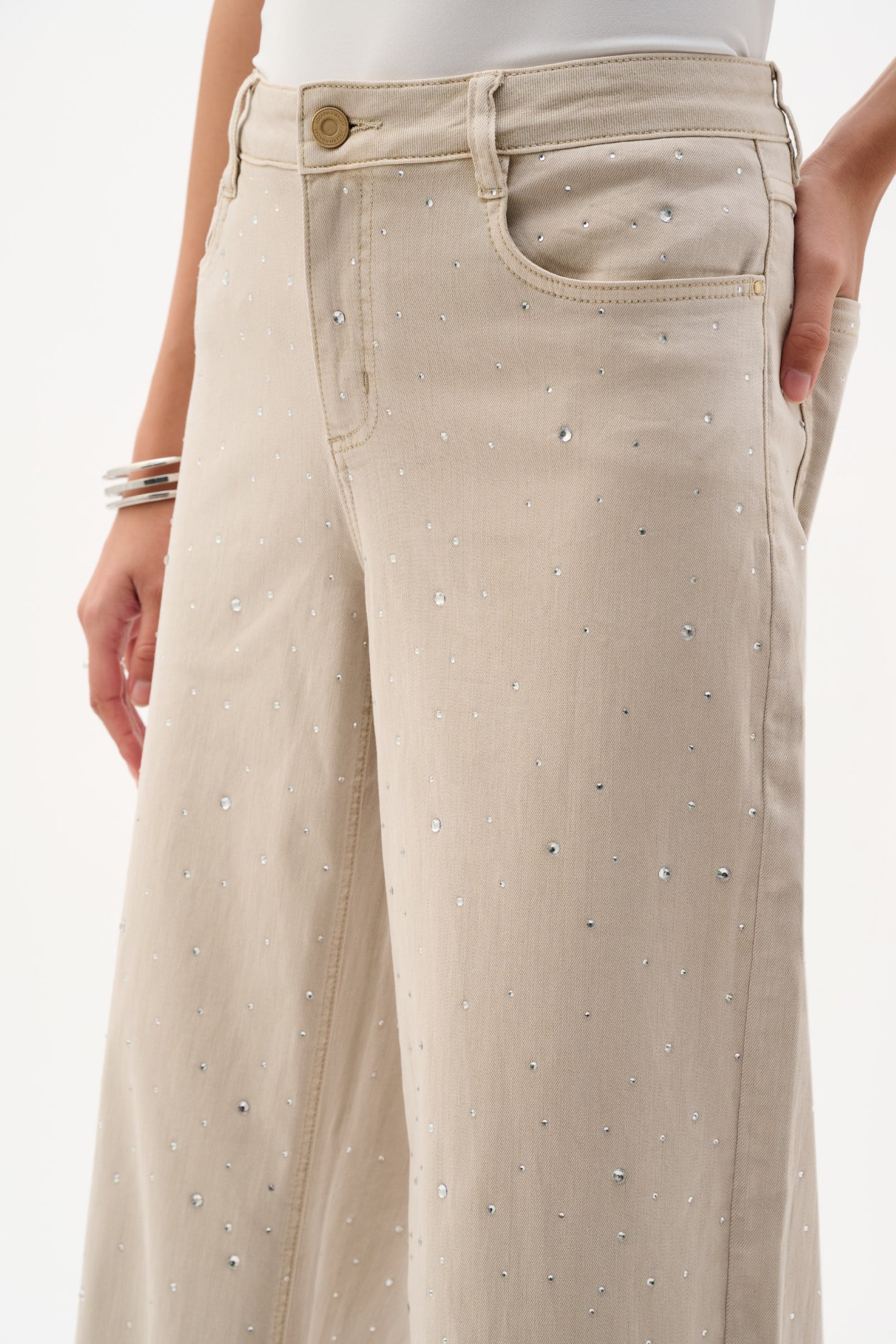 Close-up of beige jeans embellished with rhinestones styled as Joseph Ribkoff 262940 Moonstone Featherweave™ Denim Wide Leg Jeans With Rhinestones, shop Joseph Ribkoff at Dotique