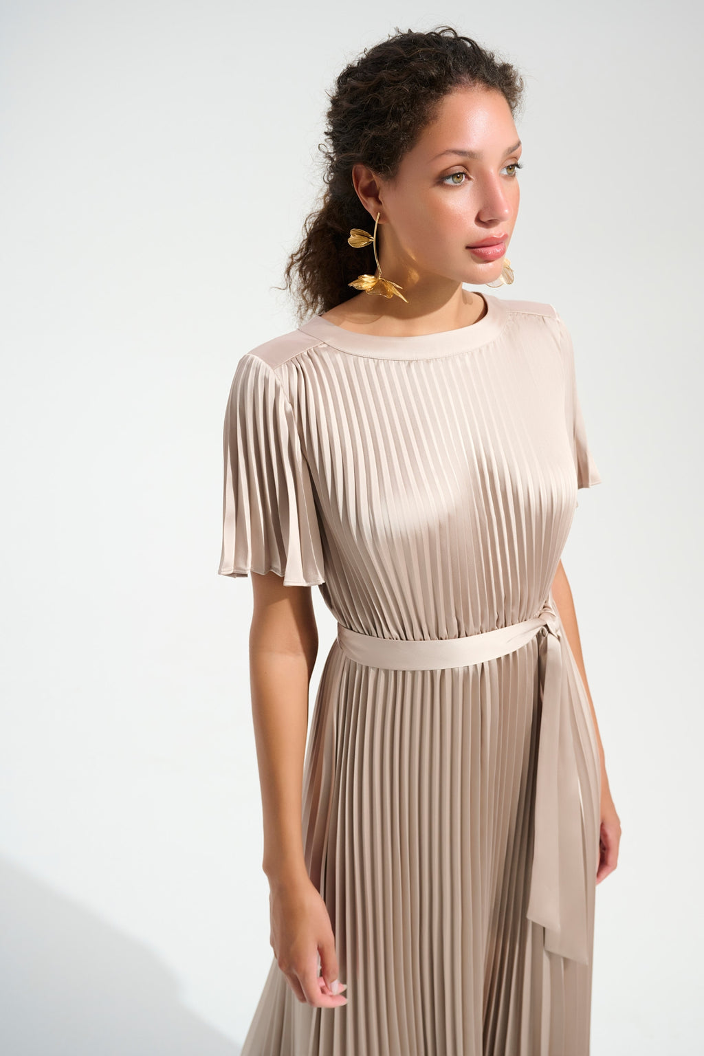 Model wearing Joseph Ribkoff 261752 Signature Pleated Satin Fit & Flare Midi Dress Champagne shop Joseph Ribkoff at Dotique