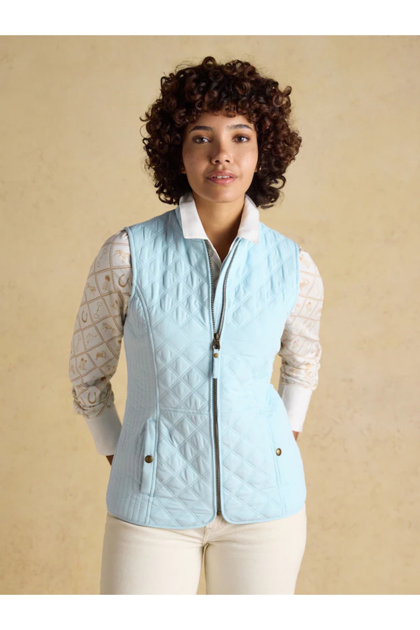 Woman wearing Joules F86654 Minx Quilted Gilet – Powder Blue from Joules, shop Joules at Dotique for stylish layering.