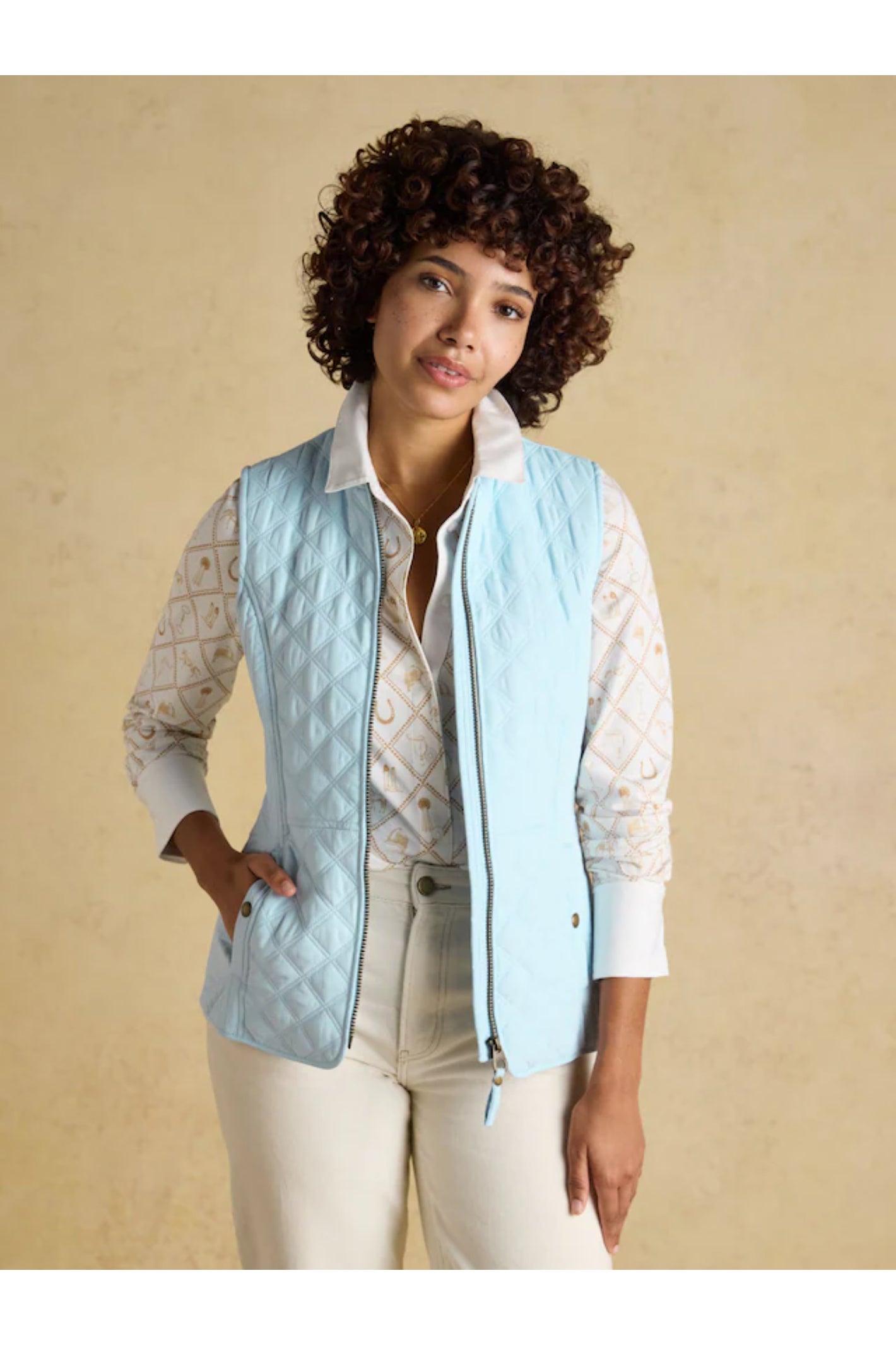 Woman wearing a powder blue Joules F86654 Minx Quilted Gilet by Joules Shop Joules at Dotique