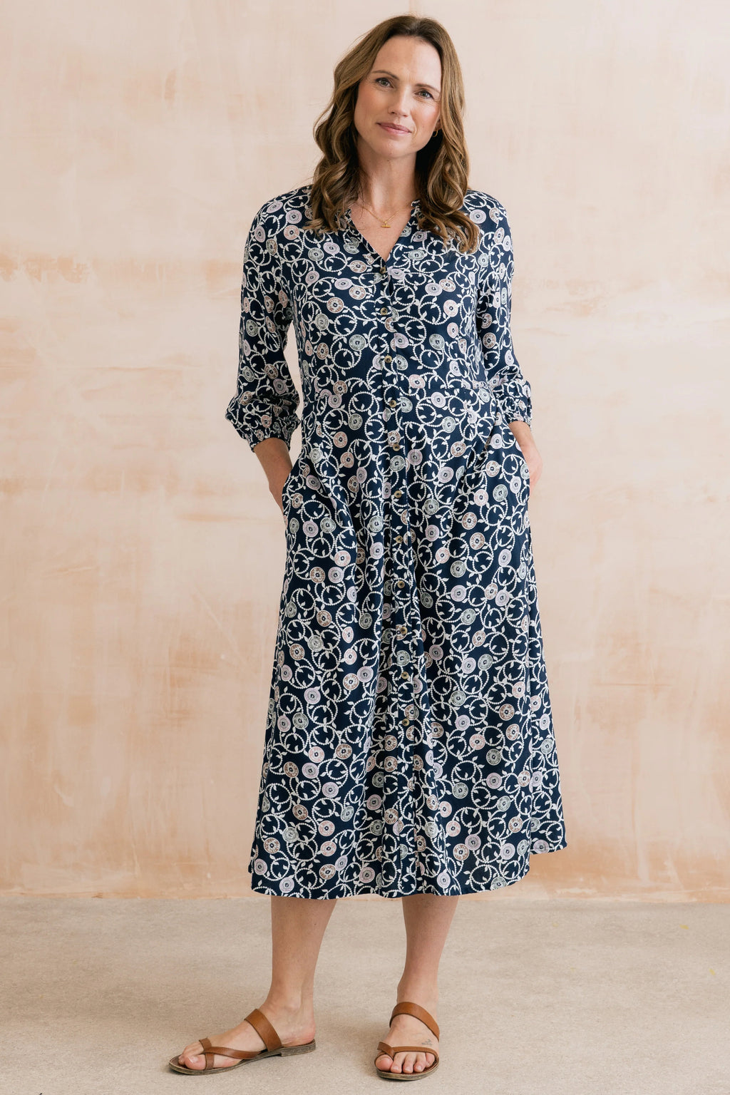 Model wearing Lily & Me LM26022 Leoni Dress Sea Holly Navy with a floral print and button front by Lily & me. Shop Lily & me at Dotique.