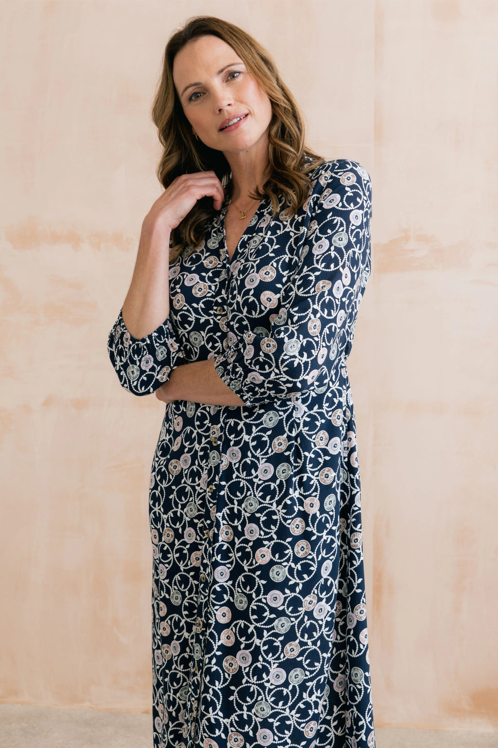 Model wearing Lily & Me LM26022 Leoni Dress Sea Holly Navy with floral pattern and button front by Lily & me. Shop Lily & me at Dotique.