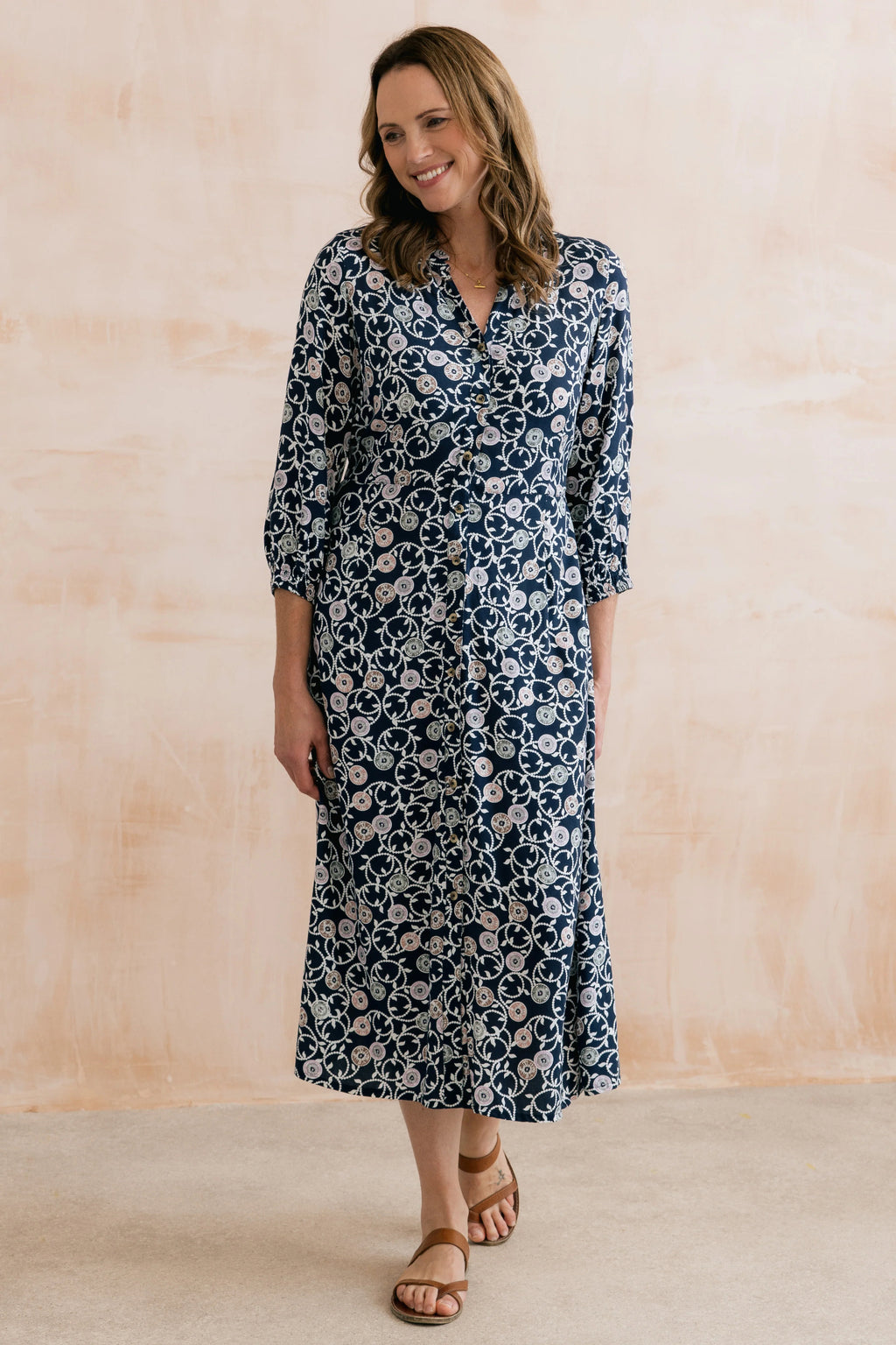 Woman modeling Lily & Me LM26022 Leoni Dress Sea Holly Navy with floral pattern and button front by Lily & me. Shop Lily & me at Dotique.