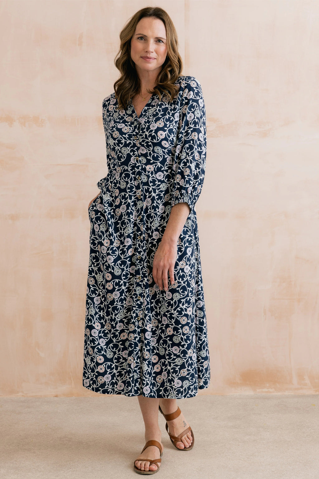 Woman modeling Lily & Me LM26022 Leoni Dress Sea Holly Navy with floral print and long sleeves by Lily & me. Shop Lily & me at Dotique.