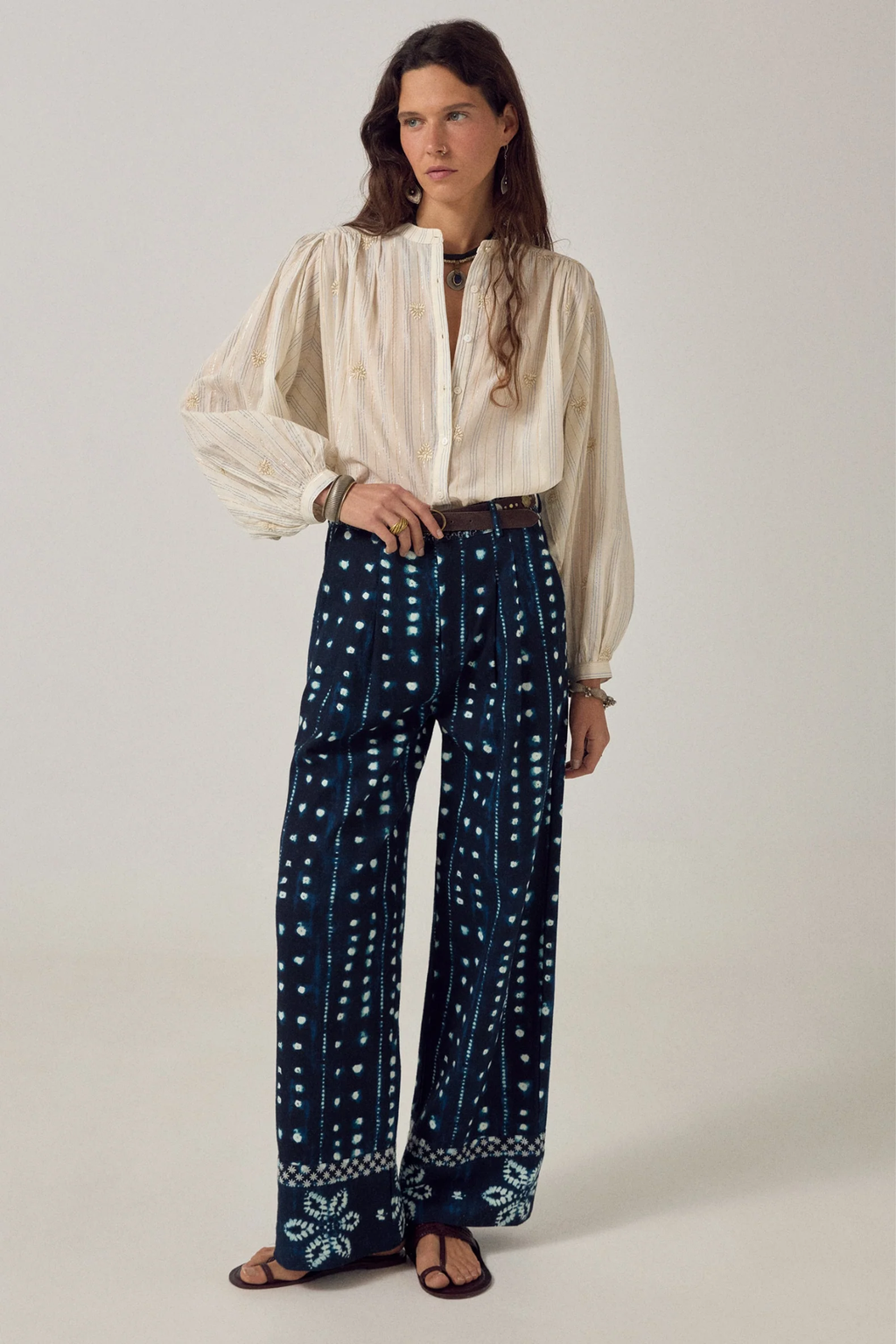Model wearing Maison Hotel Caroline Blouse Off White paired with patterned trousers, shop Maison Hotel at Dotique for elegant blouses.