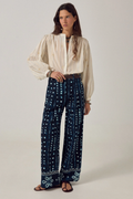 Model wearing Maison Hotel Caroline Blouse Off White paired with patterned trousers, shop Maison Hotel at Dotique for elegant blouses.