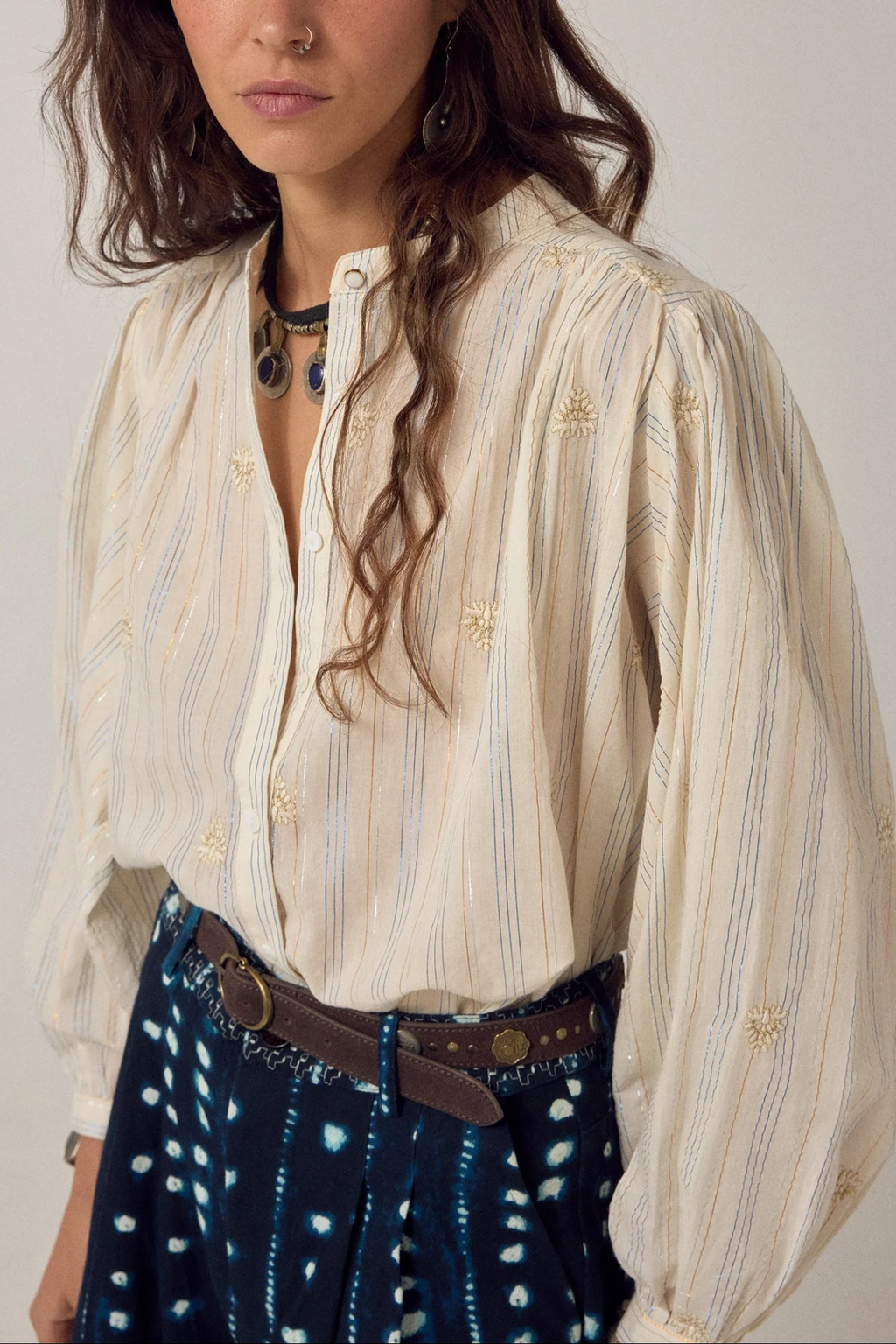 Woman wearing Maison Hotel Caroline Blouse Off White with subtle embroidery, styled with patterned trousers, shop Maison Hotel at Dotique.