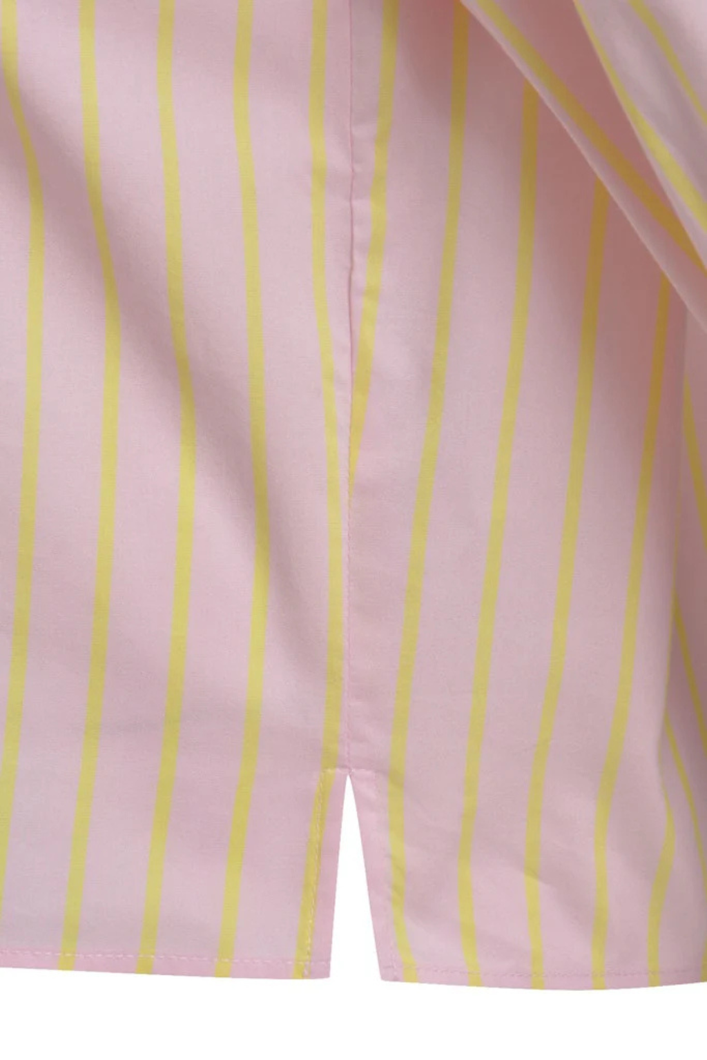 Close-up of pink shirt blouse fabric with vertical yellow stripes and a small side slit at the hem