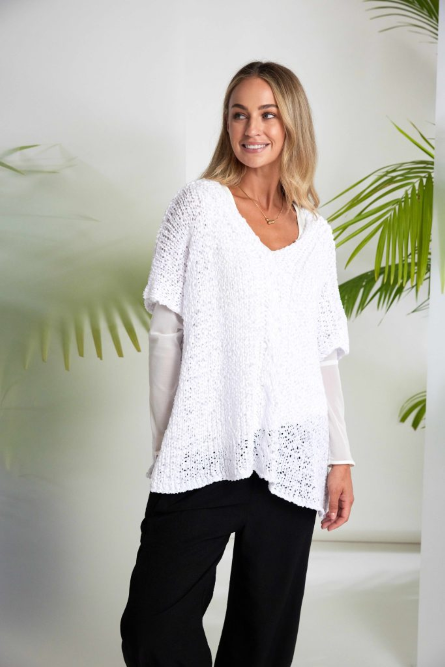 Soft off-white Naya jersey top with sheer mesh sleeves and a flattering round neckline. Easy to wear and perfect for layering. Shop at Dotique.