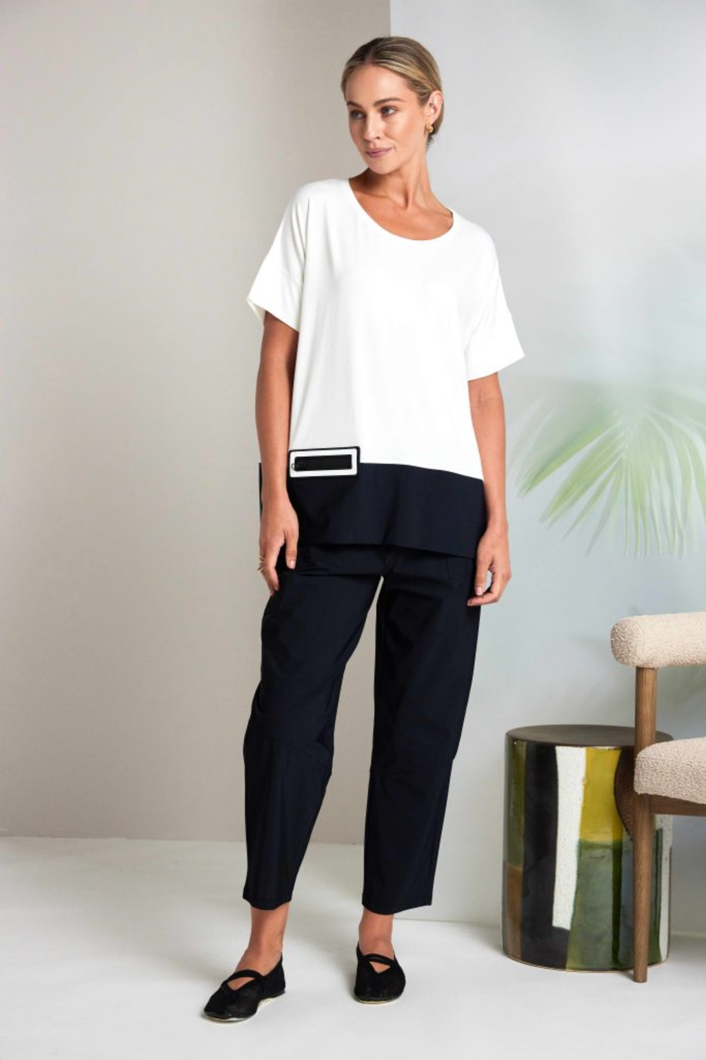 Black Naya pull-up trousers with a slim leg, stretch fabric and patch pockets. Comfortable, flattering and easy to wear. Shop now at Dotique.