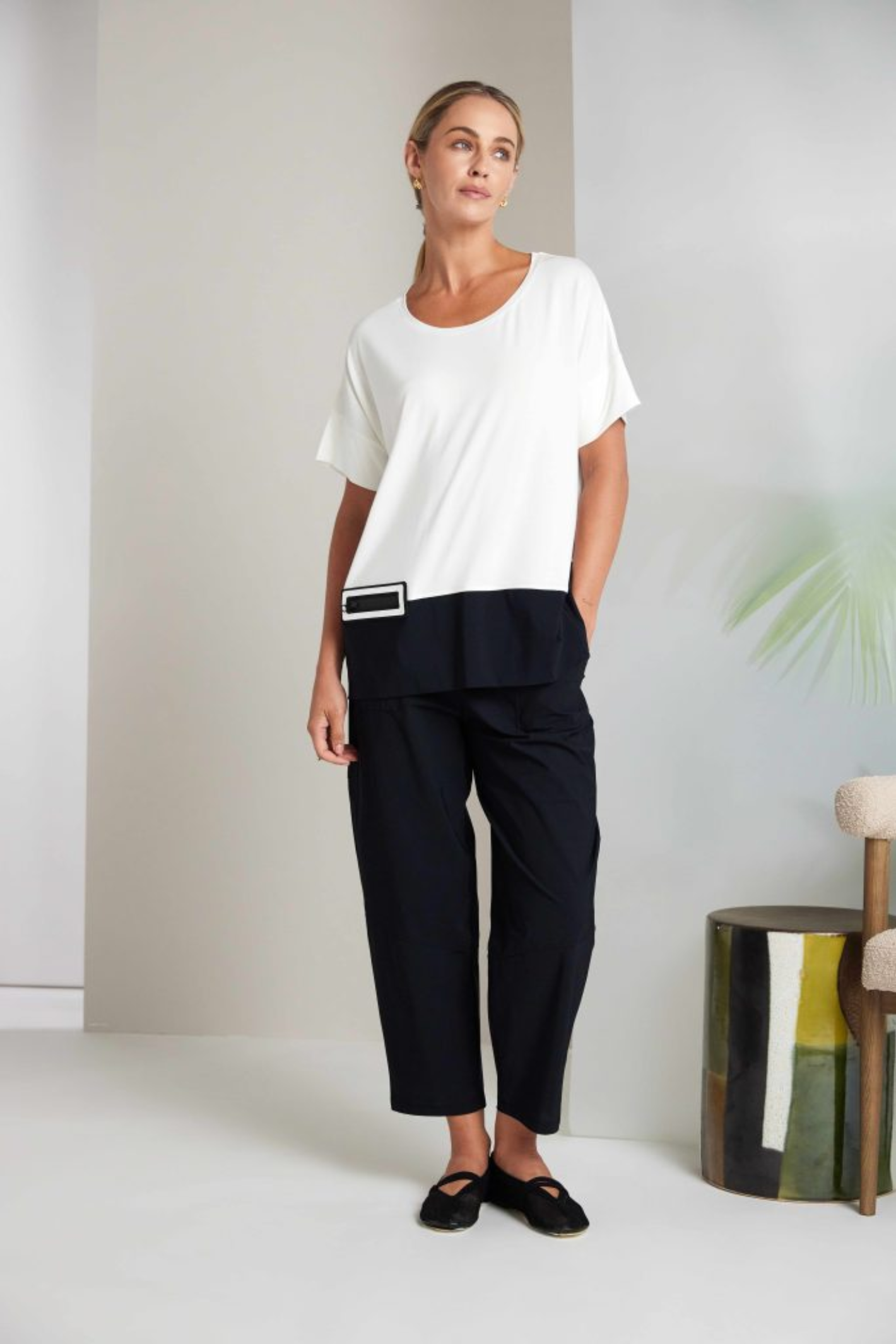 Black Naya pull-up trousers with a slim leg, stretch fabric and patch pockets. Comfortable, flattering and easy to wear. Shop now at Dotique.