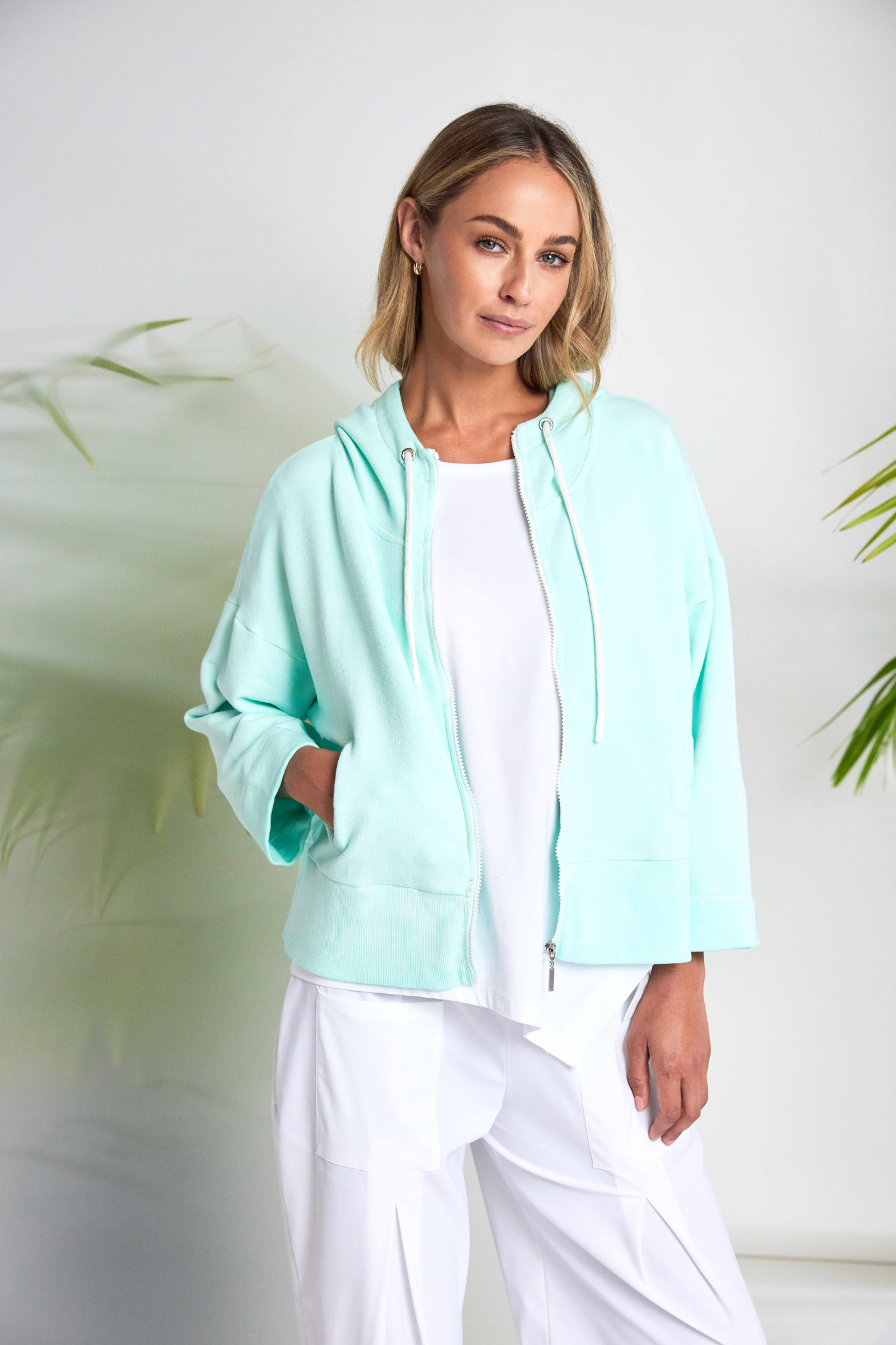 White Naya jersey top with a relaxed fit and cut-out hem detail. Soft, easy to wear and perfect for everyday. Shop at Dotique.
