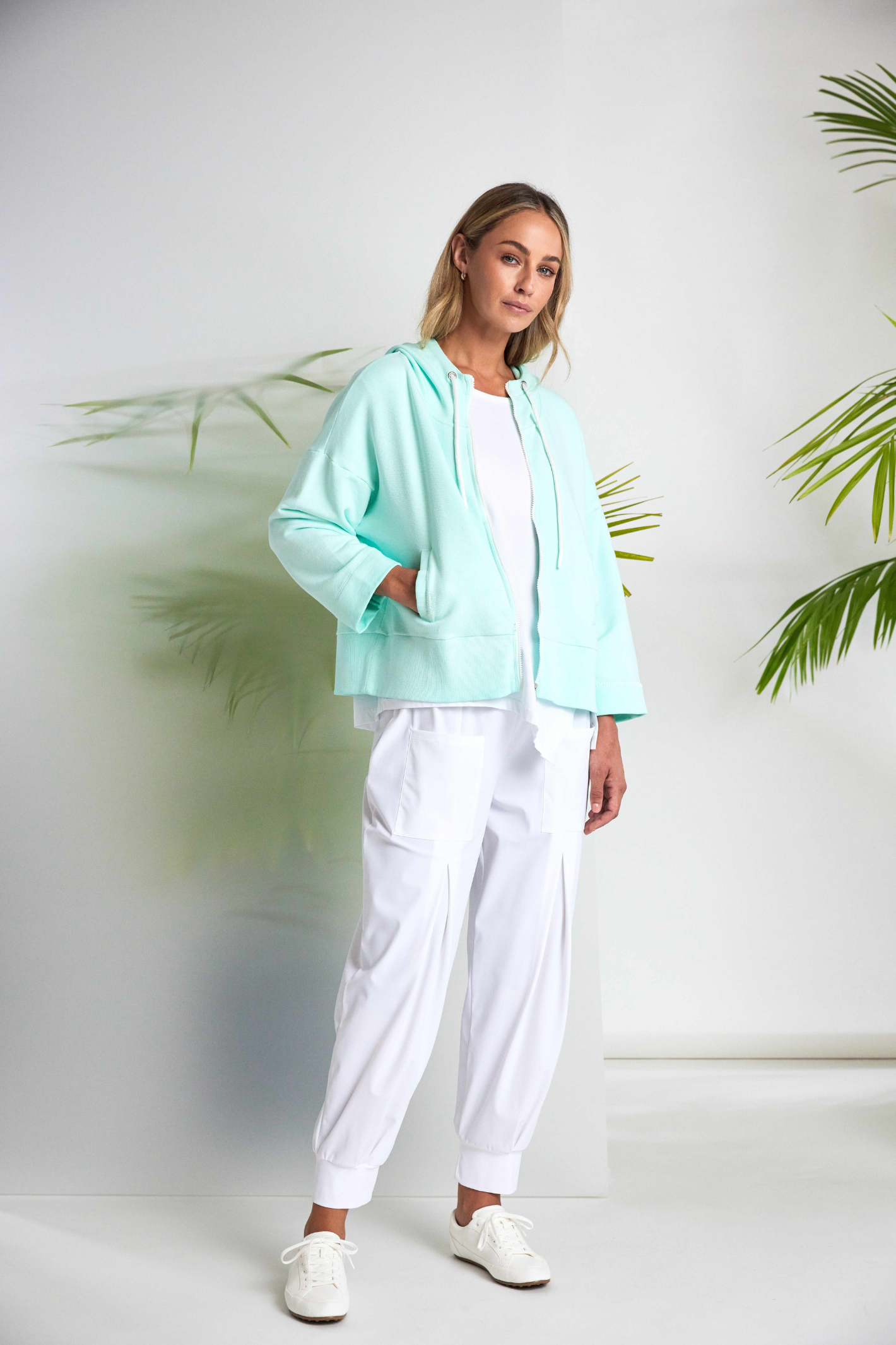 White Naya jersey top with a relaxed fit and cut-out hem detail. Soft, easy to wear and perfect for everyday. Shop at Dotique.