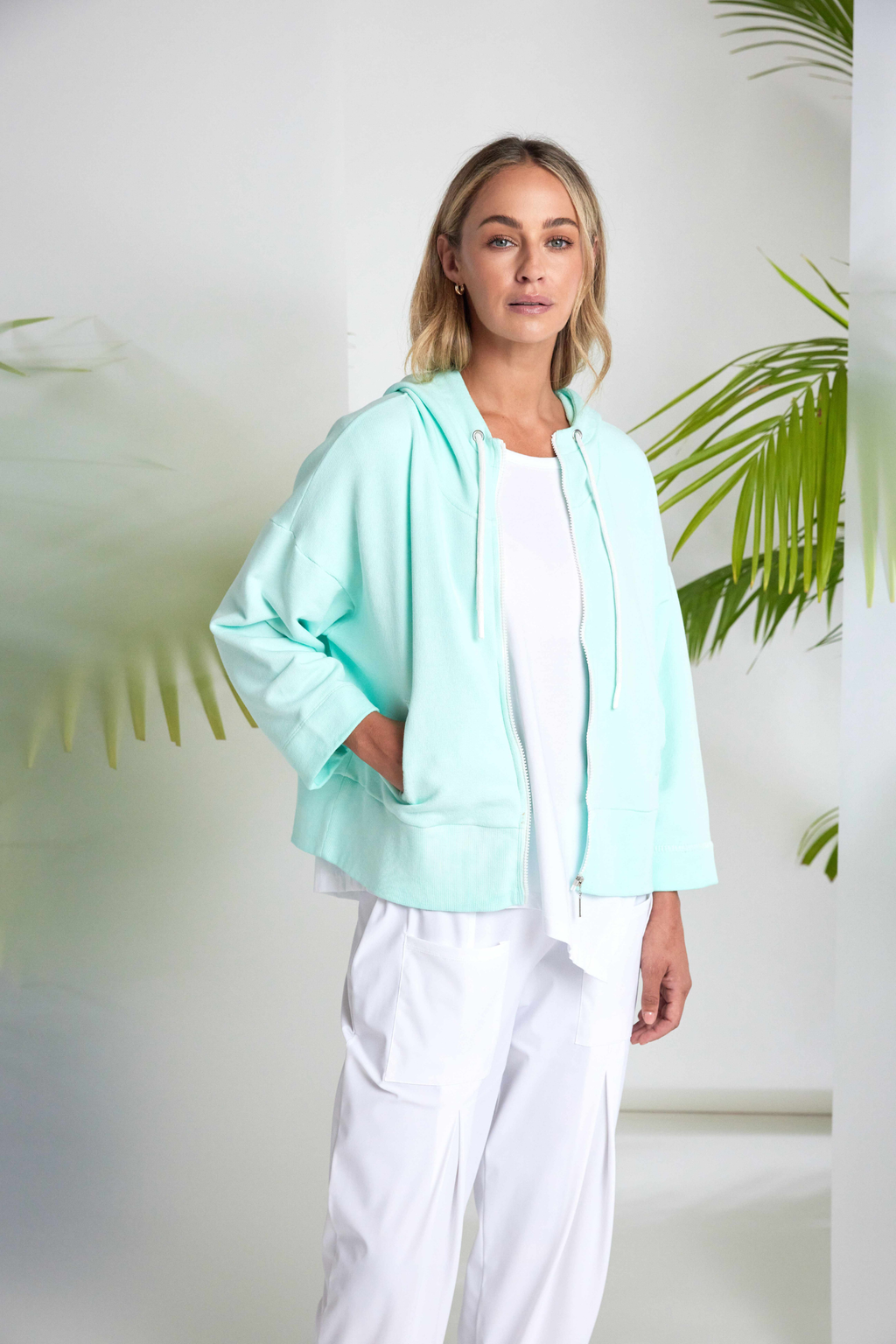 White Naya jersey top with a relaxed fit and cut-out hem detail. Soft, easy to wear and perfect for everyday. Shop at Dotique.