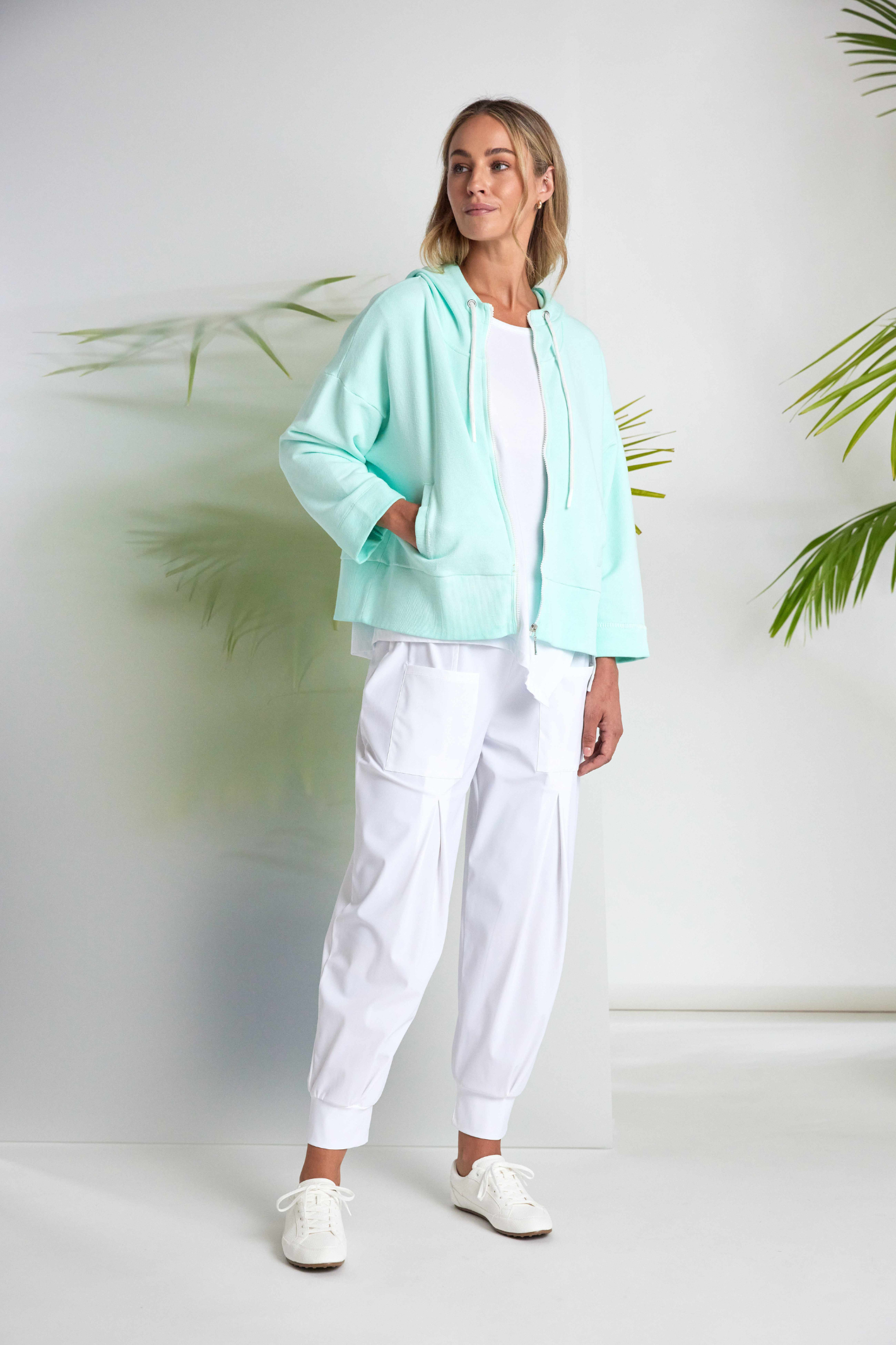 White Naya jersey top with a relaxed fit and cut-out hem detail. Soft, easy to wear and perfect for everyday. Shop at Dotique.