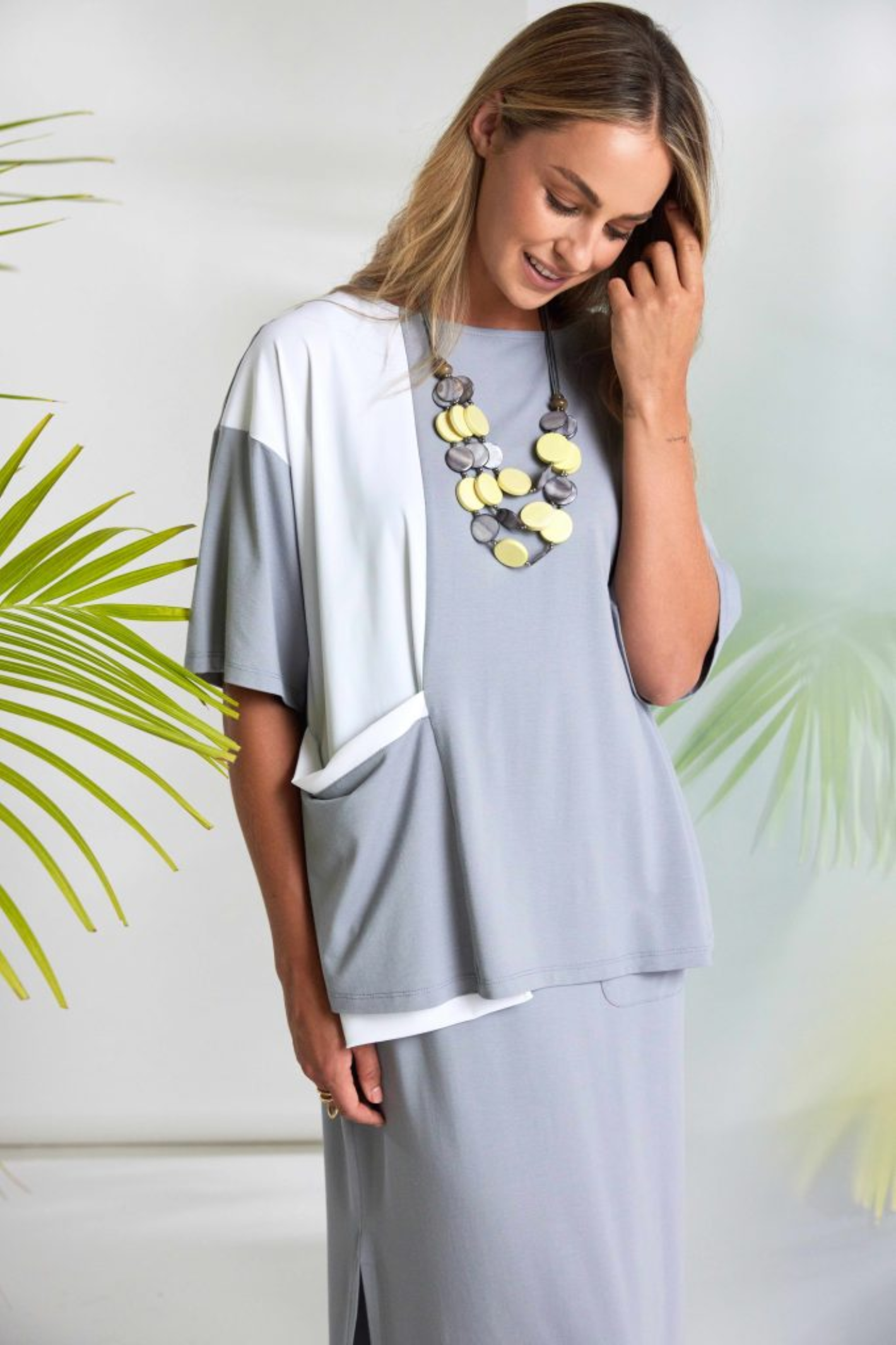Soft dove grey Naya jersey dress with wide straps, side slit and patch pocket. Flattering, comfortable and easy to wear. Shop at Dotique.