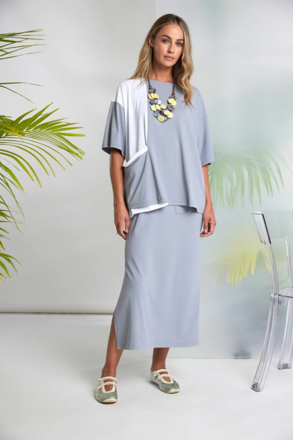 Soft dove grey Naya jersey dress with wide straps, side slit and patch pocket. Flattering, comfortable and easy to wear. Shop at Dotique.