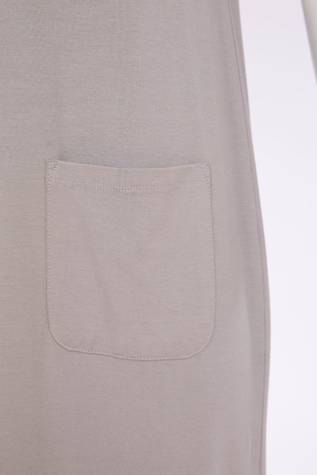 Soft taupe Naya jersey dress with wide straps, side slit and patch pocket. Comfortable, flattering and easy to wear. Shop at Dotique.