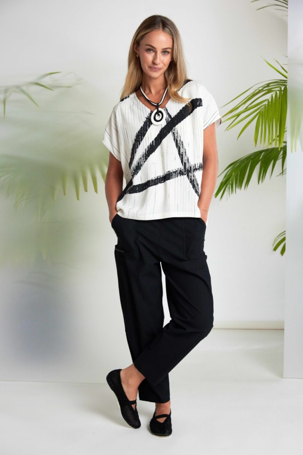 Black Naya elastic waist trousers with patch pocket and stretch fabric. Comfortable, flattering and easy to wear every day. Shop at Dotique.