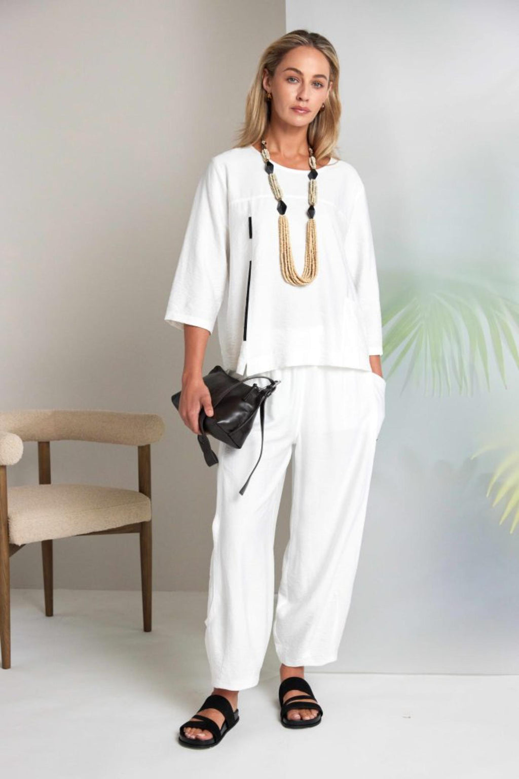 Model wearing Naya NAS26153 White Pull-On Trousers by Naya, shop Naya styles at Dotique for effortless relaxed elegance