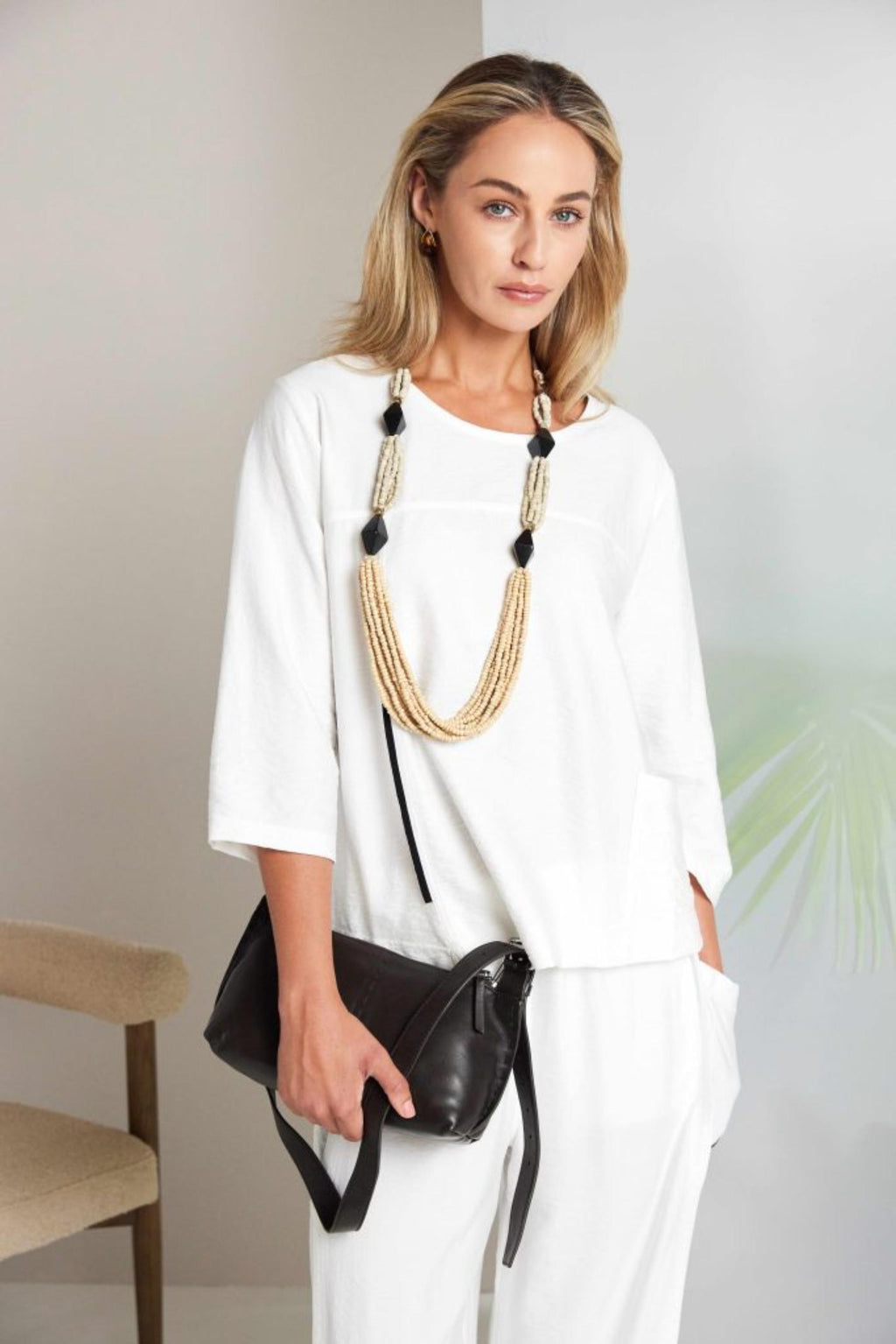 Model wearing Naya NAS26153 White Pull-On Trousers by Naya, shop Naya styles for relaxed chic looks at Dotique