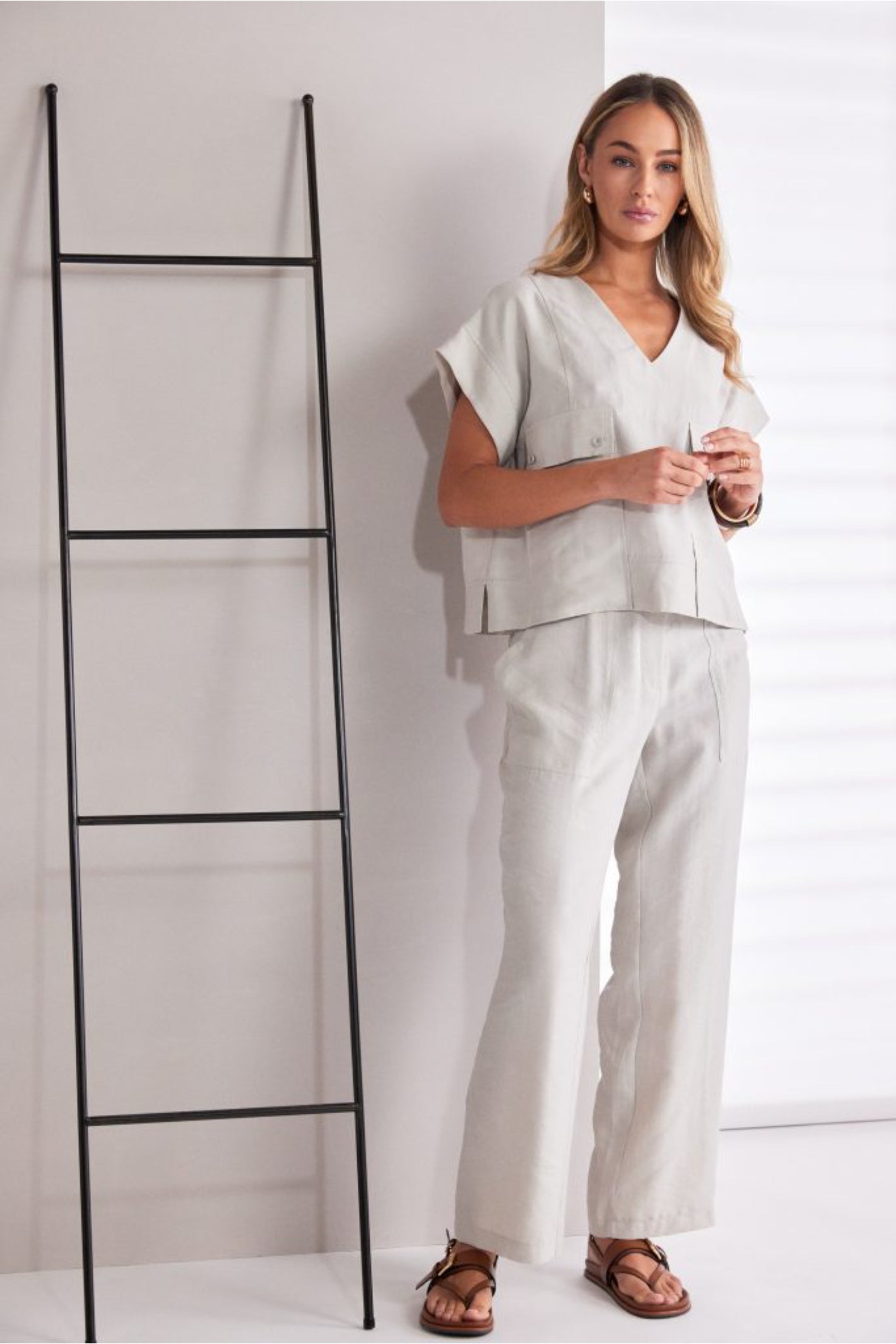 Model wearing Naya NPA26220 Patch Pocket Vee Neck Top With Button Detail Ash by Naya, styled with matching trousers, shop Naya at Dotique.