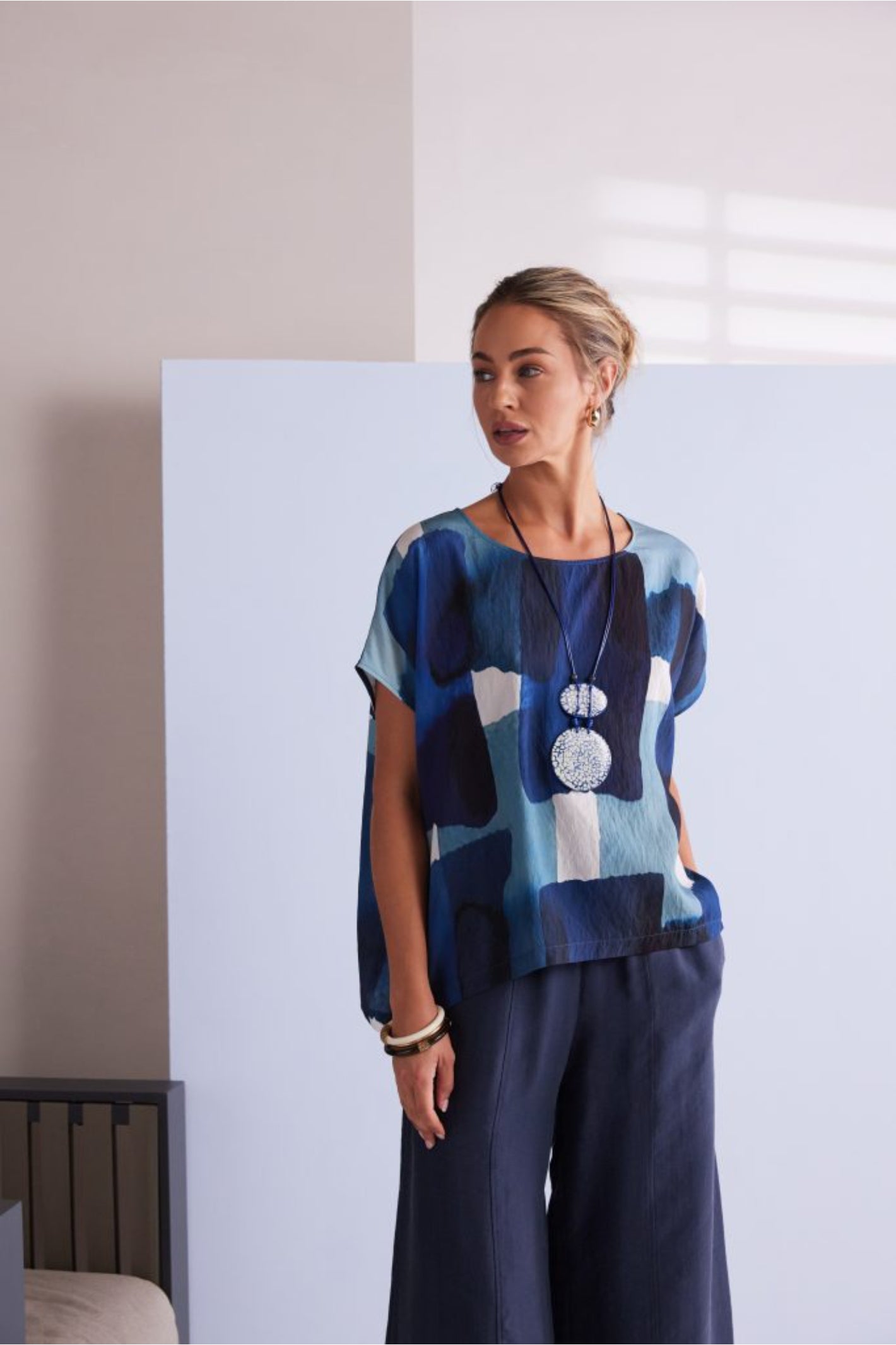 NAYA blue multi abstract print top featuring a round neckline, short sleeves and an artistic patchwork design.