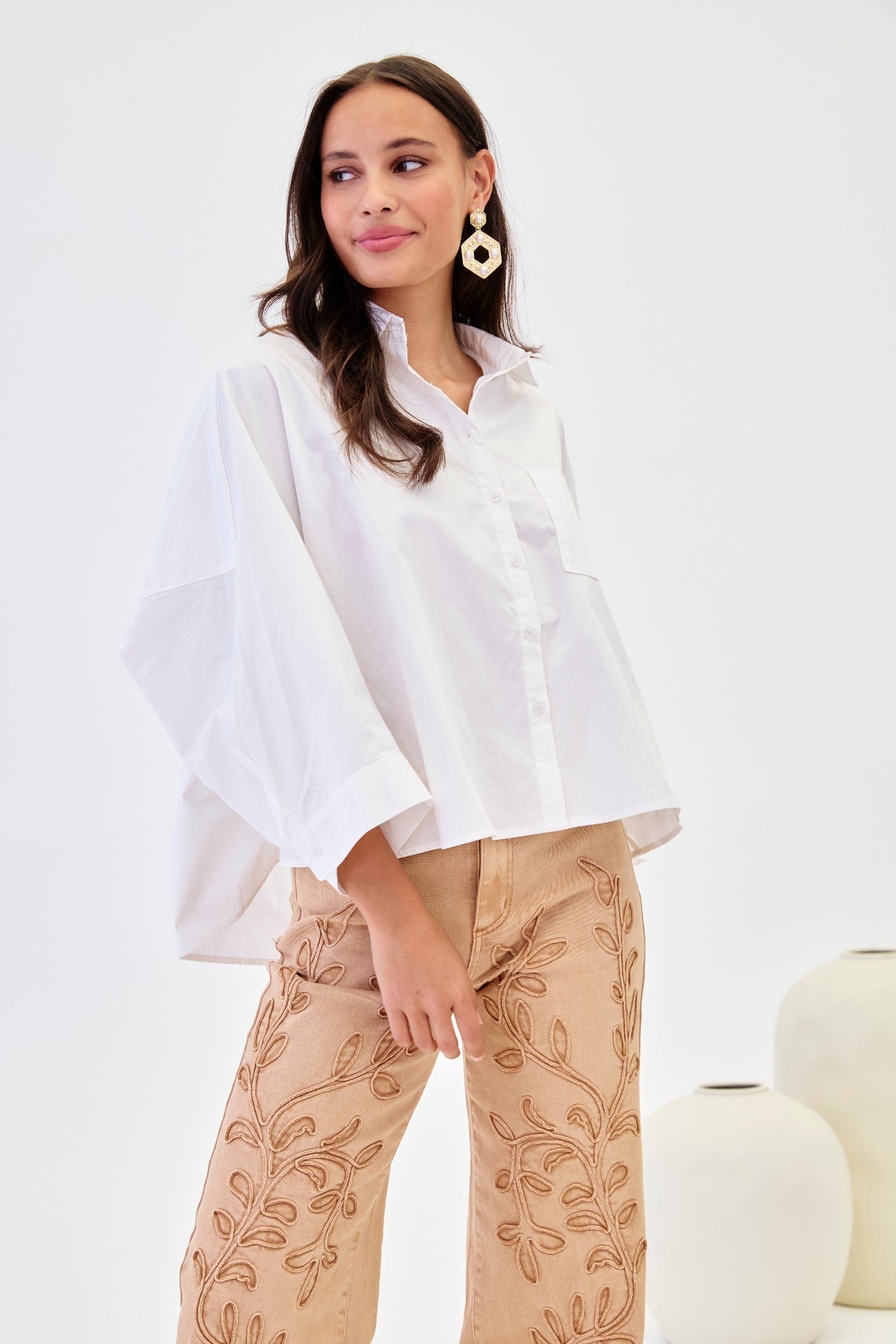 Woman wearing Nekane Vumi White Oversized Cotton Shirt by NKN Nekane, shop NKN Nekane at Dotique for stylish cotton shirts