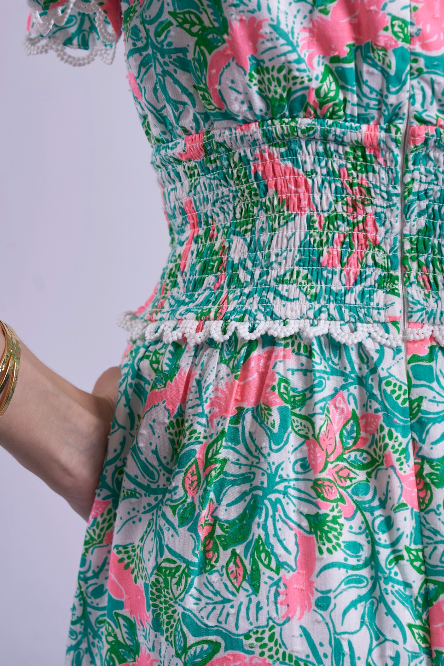 Close-up of floral pattern and smocked waist detail on New Day Originals Misha Pink Parrot by New Day Originals, shop New Day Originals at Dotique