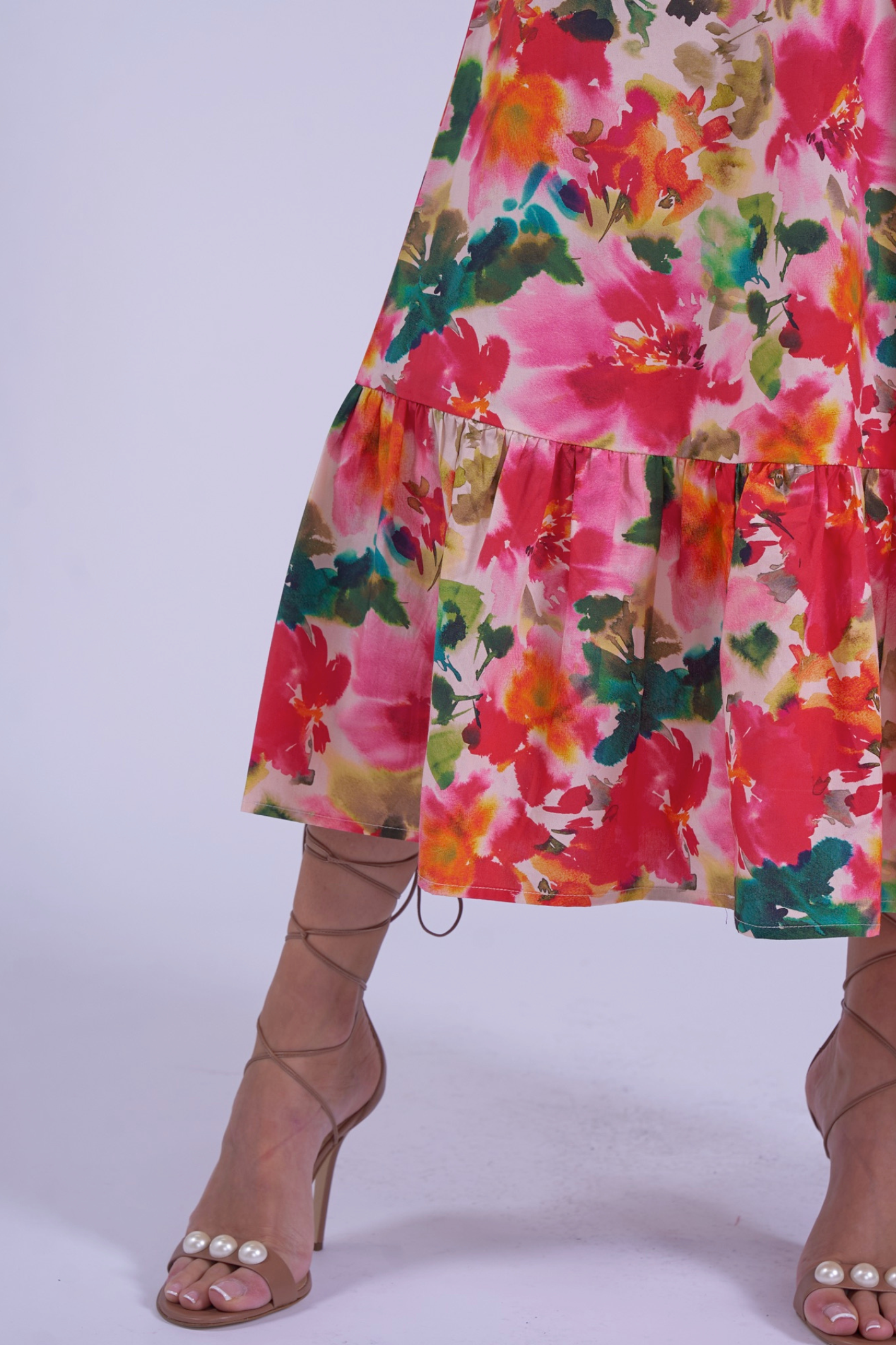 Close-up of colorful floral print skirt hem on New Day Originals Universe Dress Summer Bouquet by New Day Originals shop Dotique