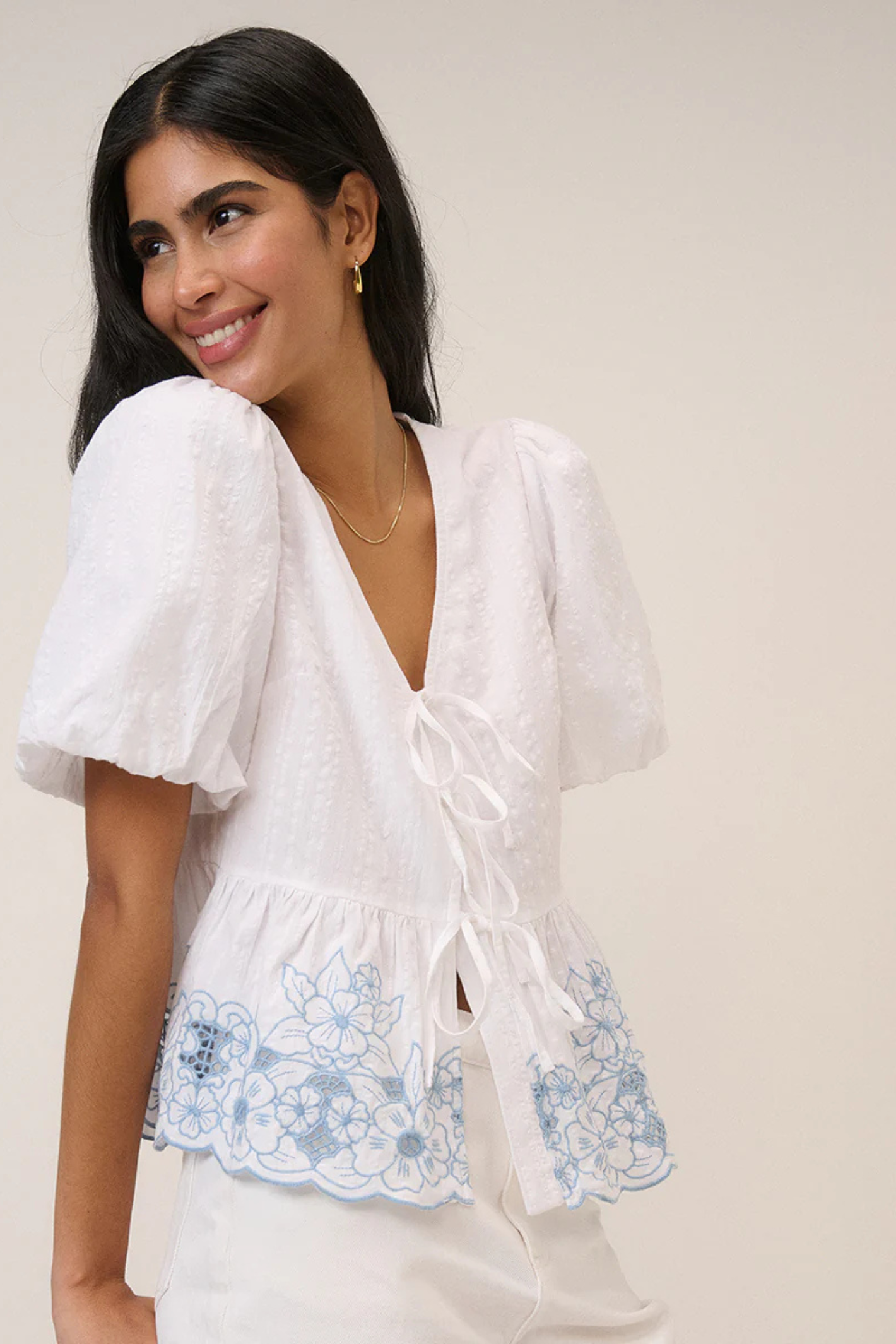 Woman wearing Nobody's Child Aries White Floral Embroidered Blouse by Nobody’s Child, shop Nobody’s Child at Dotique.