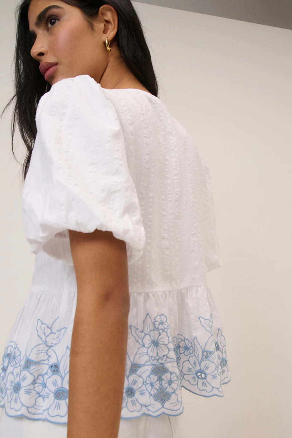 Model wearing Nobody's Child Aries White Floral Embroidered Blouse by Nobody’s Child Shop at Dotique.