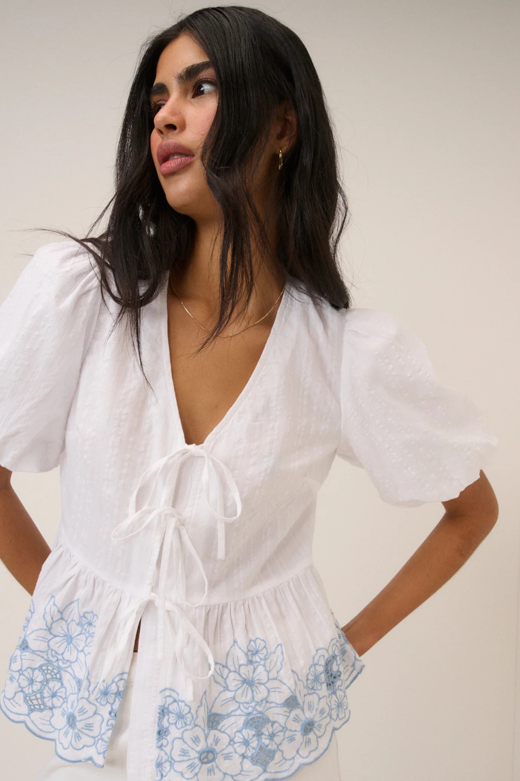 Model wearing Nobody's Child Aries White Floral Embroidered Blouse by Nobody’s Child, shop the brand at Dotique.