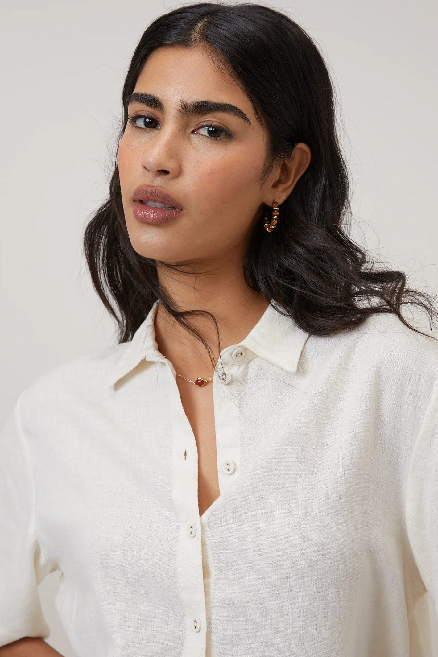 Close-up of a woman wearing Nobody's Child Bennie Linen Blend Cropped Shirt Cream by Nobody’s Child Shop at Dotique