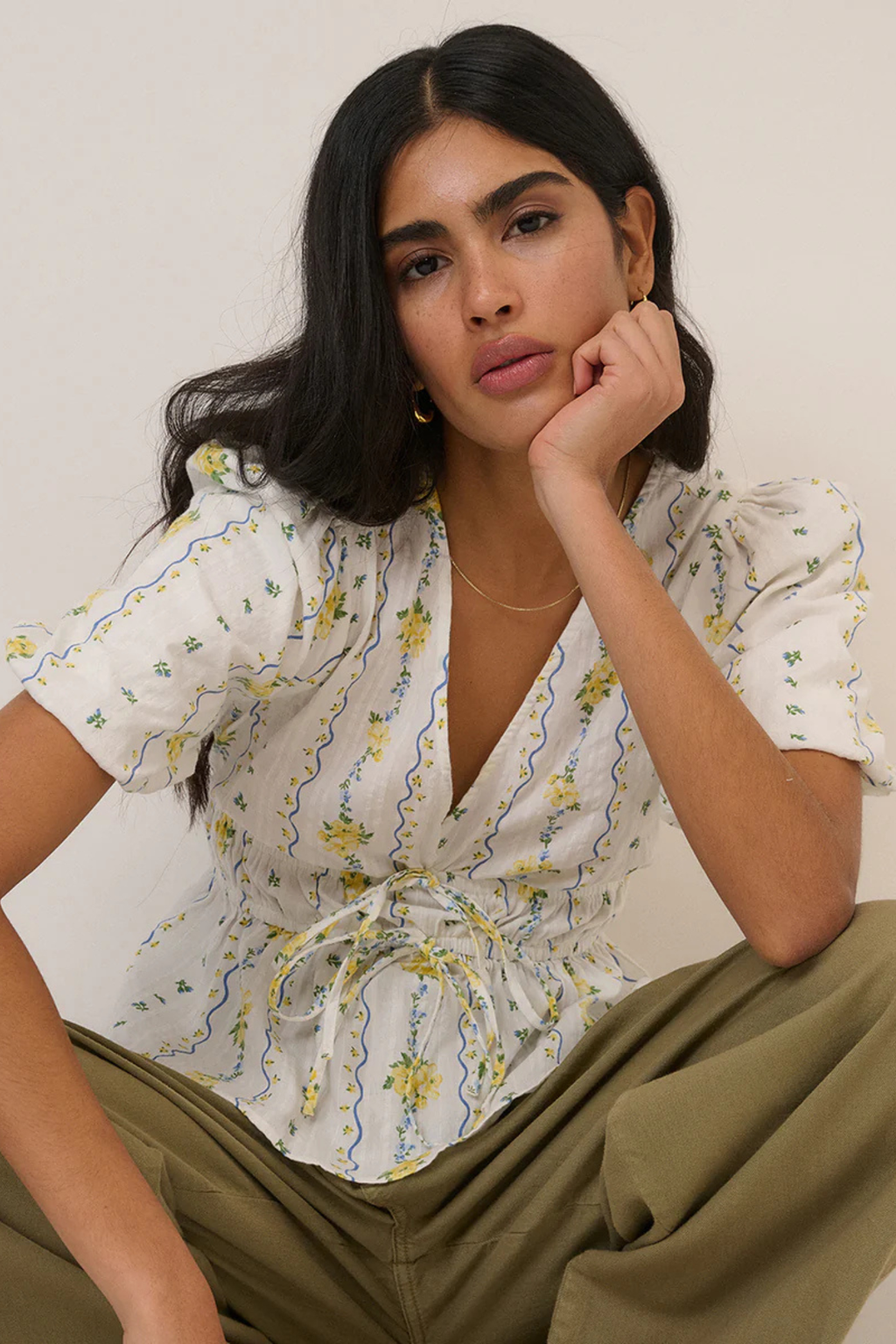 Woman wearing Nobody's Child White Ditsy Floral Cordelia Top by Nobody’s Child, shop Nobody’s Child at Dotique.