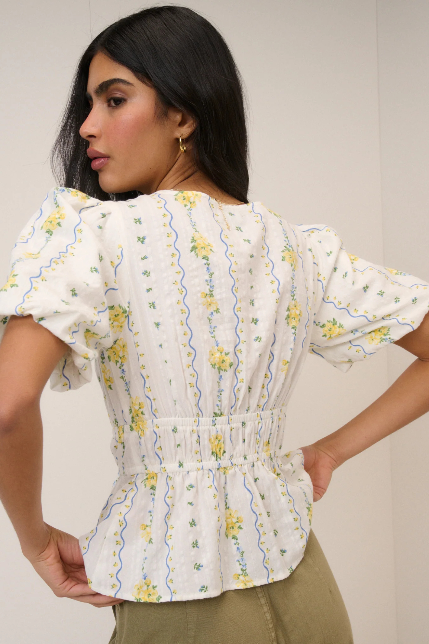 Woman wearing Nobody's Child White Ditsy Floral Cordelia Top by Nobody’s Child, shop Nobody’s Child at Dotique online.