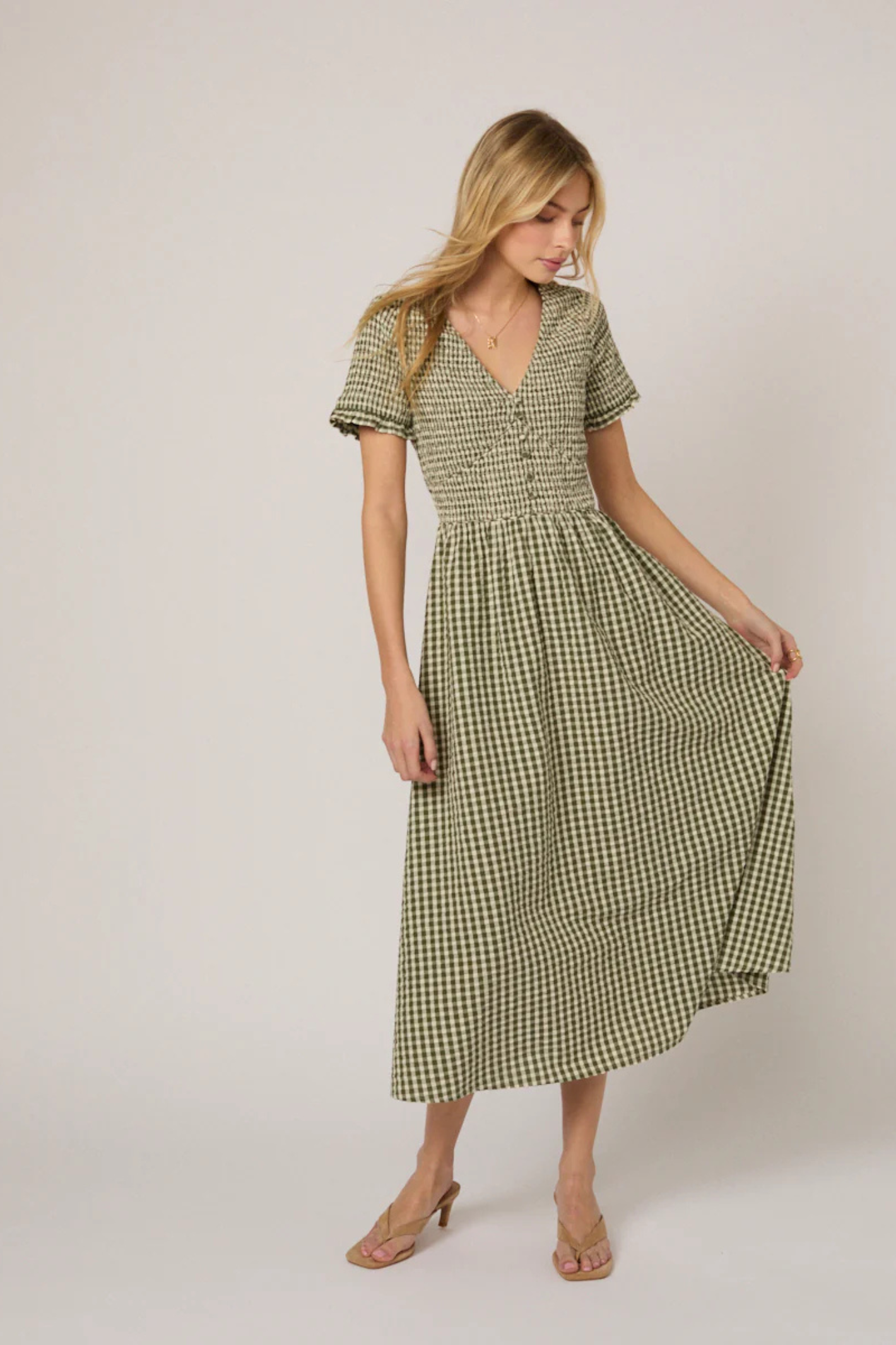 Woman wearing Nobody's Child Eliza Green Gingham Organic Cotton Midi Dress by Nobody’s Child, shop Nobody’s Child at Dotique.