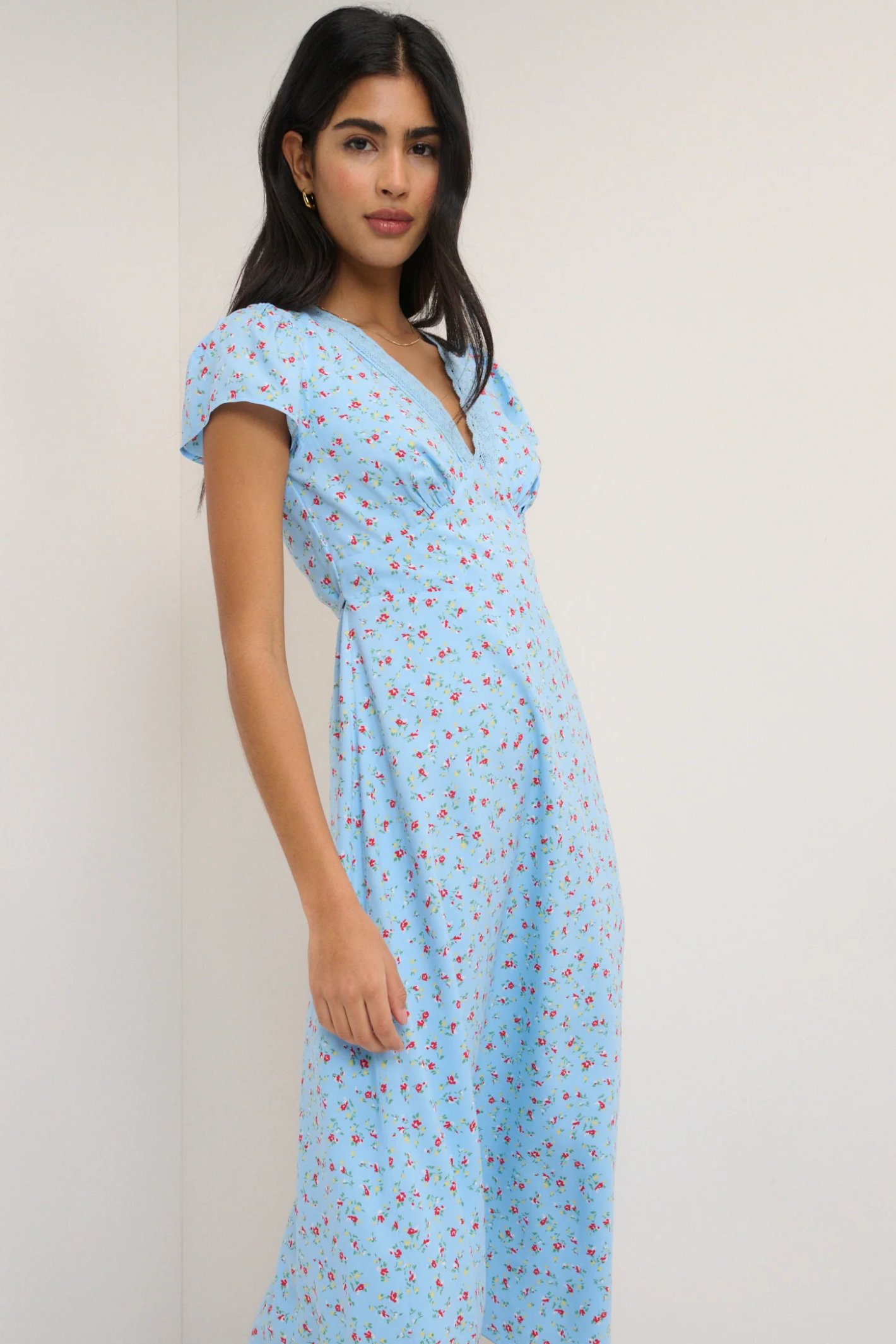 Model wearing Nobody’s Child Kacey Blue Ditsy Floral Midi Dress by Nobody’s Child, shop Nobody’s Child at Dotique.